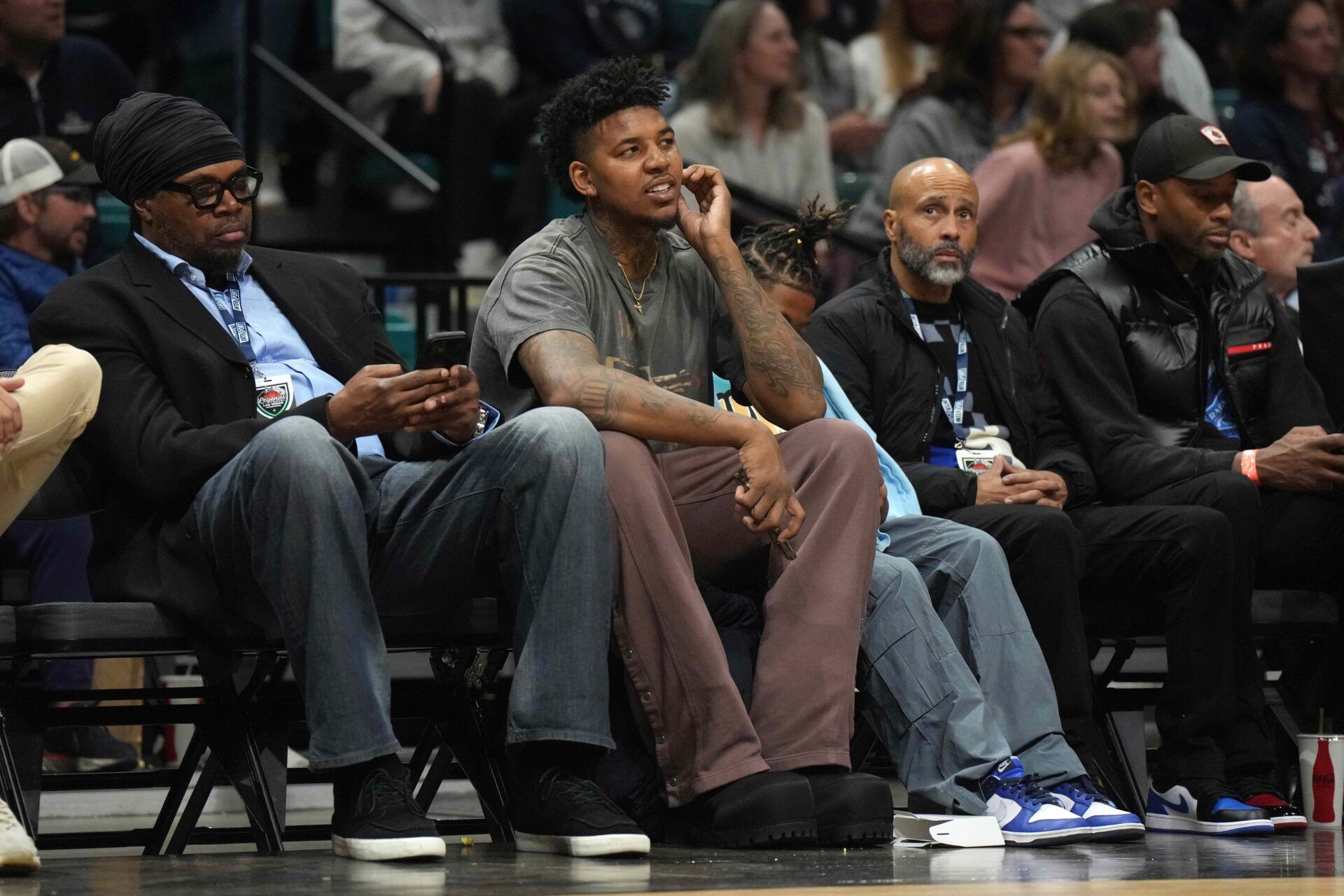 Nick Young (center) watches during the Legends of Basketball Las Vegas Invitational between the Southern California Trojans and the Gonzaga Bulldogs at MGM Grand Garden Arena.
