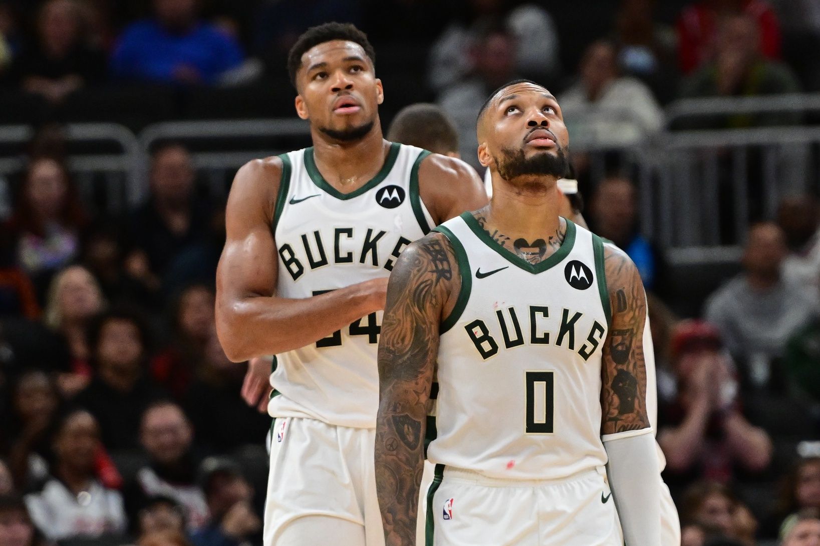 Milwaukee Bucks forward Giannis Antetokounmpo (34) and guard Damian Lillard (0) look on in the second quarter against the Chicago Bulls at Fiserv Forum.
