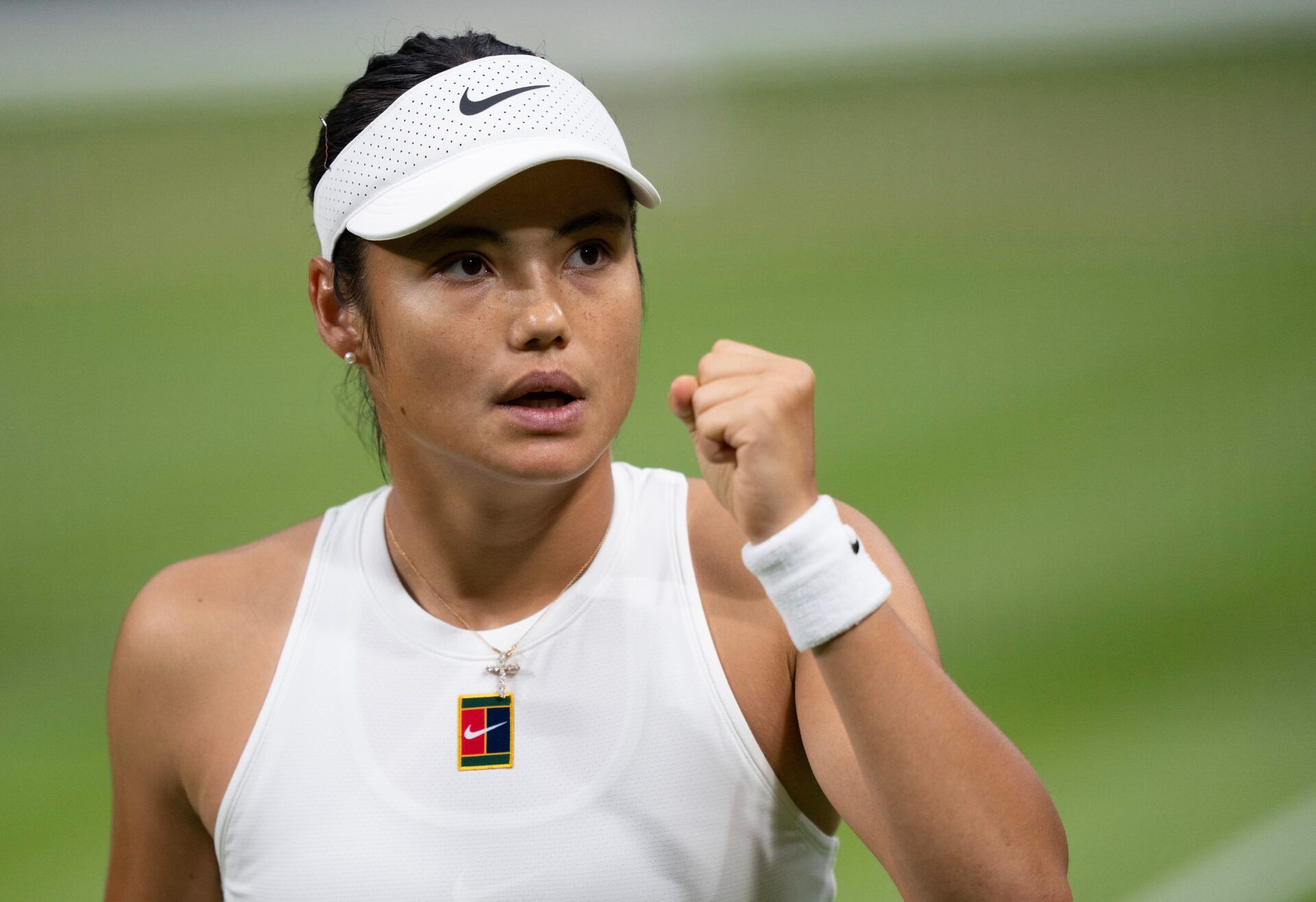 Emma Raducanu of Great Britain returns a shot during her match against Aryna Sabalenka on day five at the All England Lawn Tennis and Croquet Club.