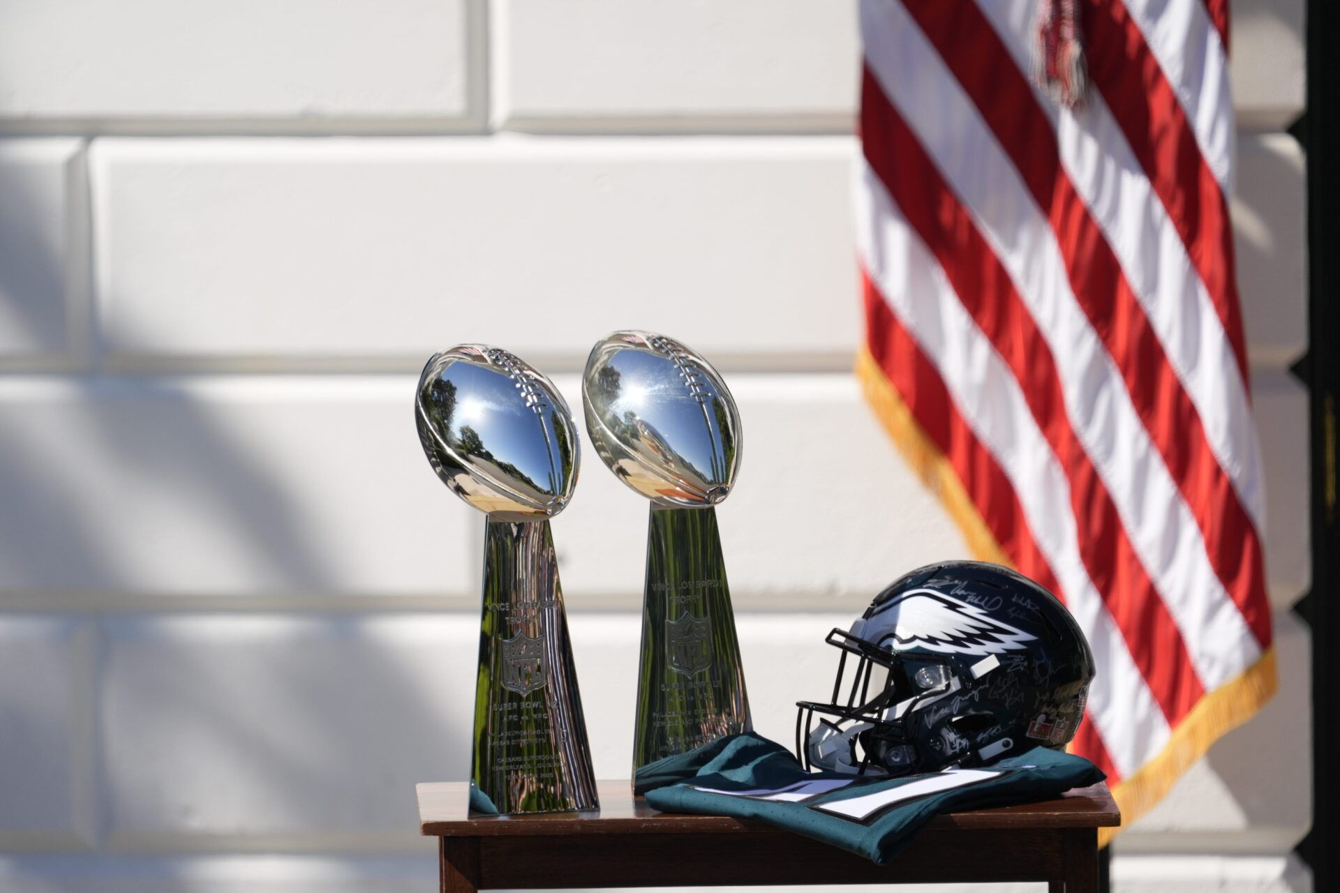 Two Vince Lombardi Trophies, a helmet and jersey on a table before President Donald Trump honors the Super Bowl LIX champion Philadelphia Eagles at The White House in Washington D.C., on April 28, 2025.