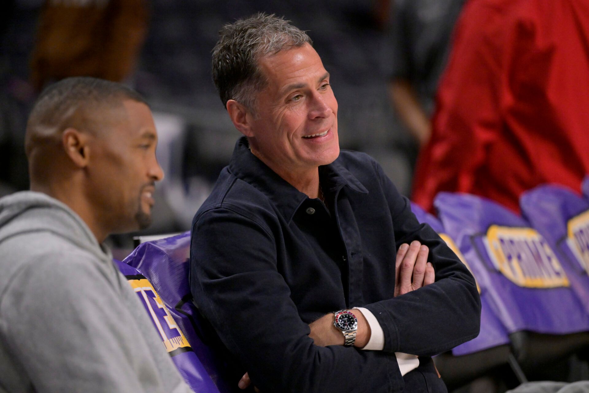 Los Angeles Lakers general manager Rob Pelinka, right, talks with Leroy Sims, director of player performance & health, prior to the game against the Orlando Magic at Crypto.com Arena.