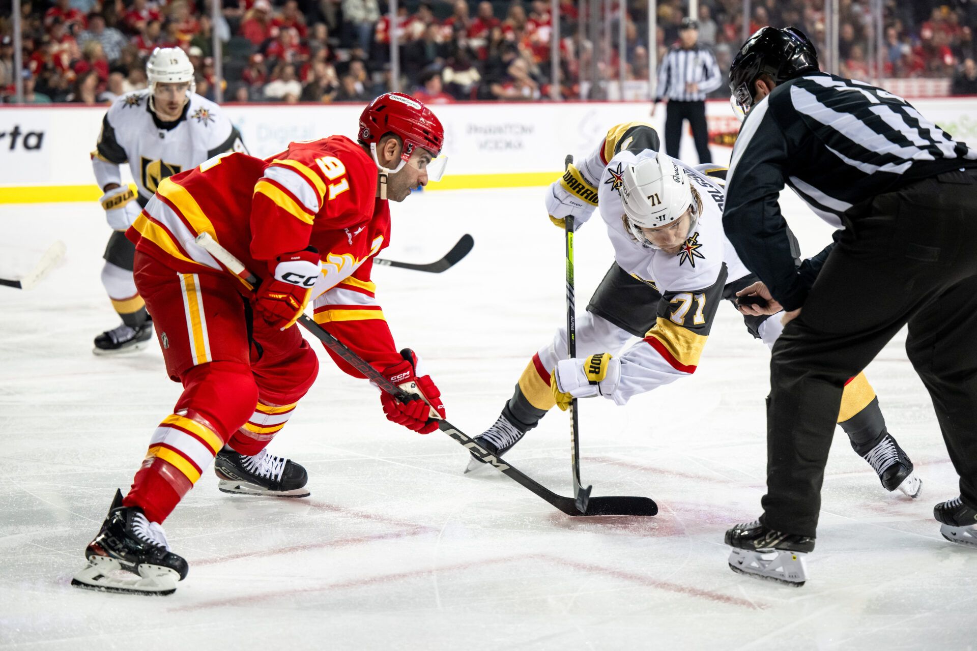Calgary Flames center Nazem Kadri (91) and Vegas Golden Knights center William Karlsson (71) take a face-off during the first period at Scotiabank Saddledome.
