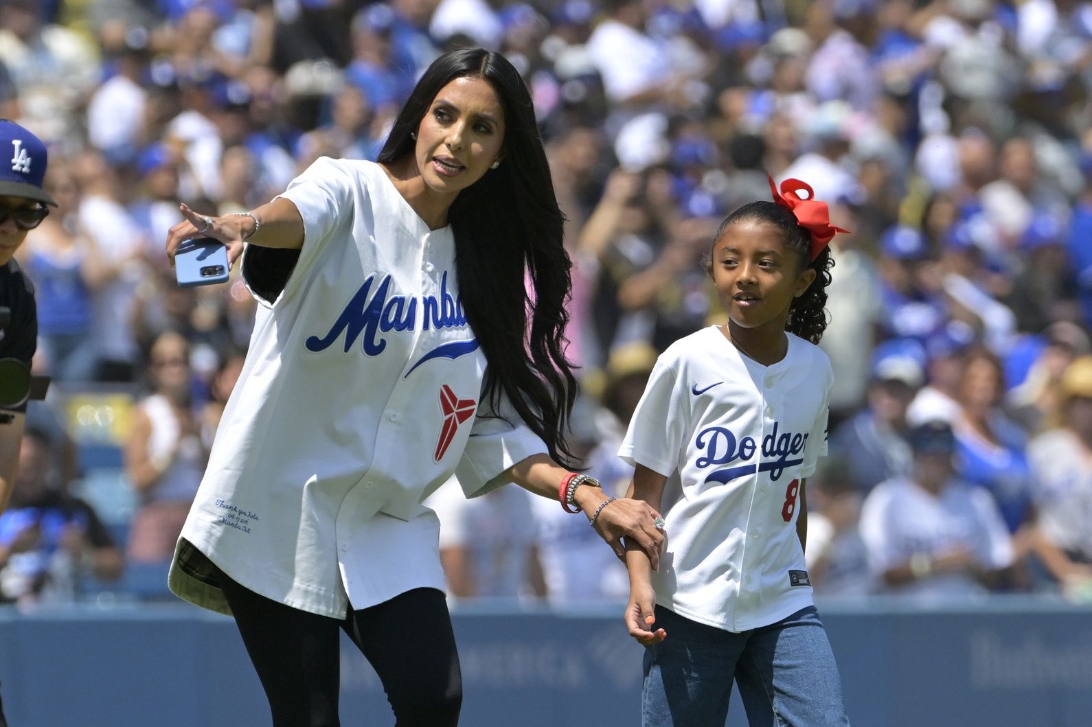 Vanessa Bryant, widow of Los Angeles Lakers Kobe Bryant, accompanies their daughter Bianka, 7, to the mound to throw out the first pitch against the Tampa Bay Rays on Sunday, Aug. 25. at Dodger Stadium.