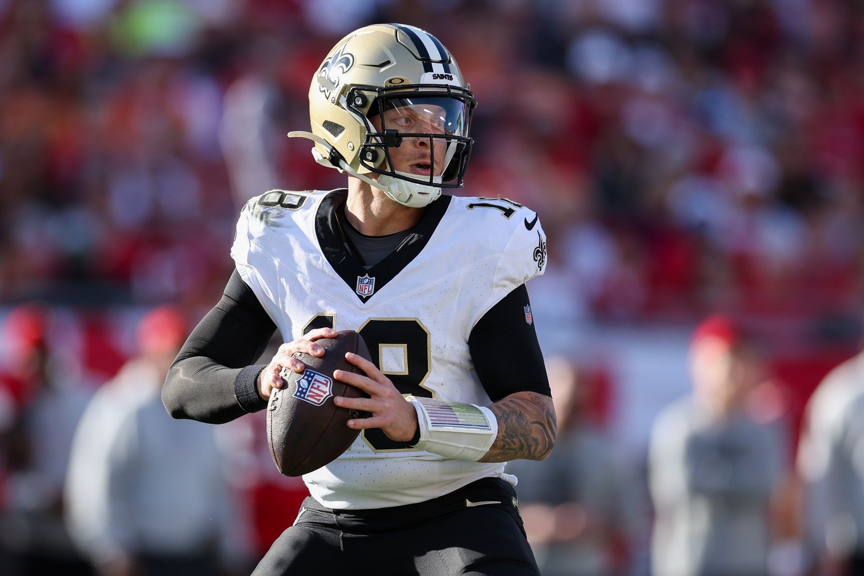New Orleans Saints quarterback Spencer Rattler (18) drops back to pass against the Tampa Bay Buccaneers in the fourth quarter at Raymond James Stadium.