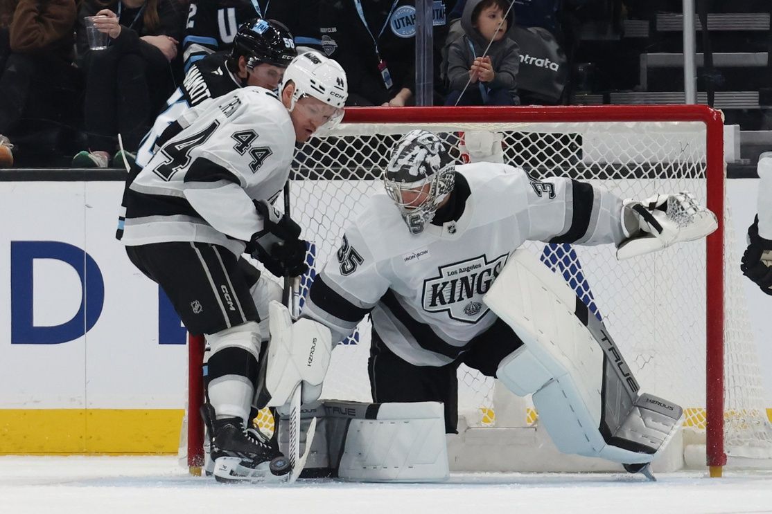 Los Angeles Kings goaltender Darcy Kuemper (35) and defenseman Mikey Anderson (44) clear the puck from the Utah Hockey Club during the third period at Delta Center.
