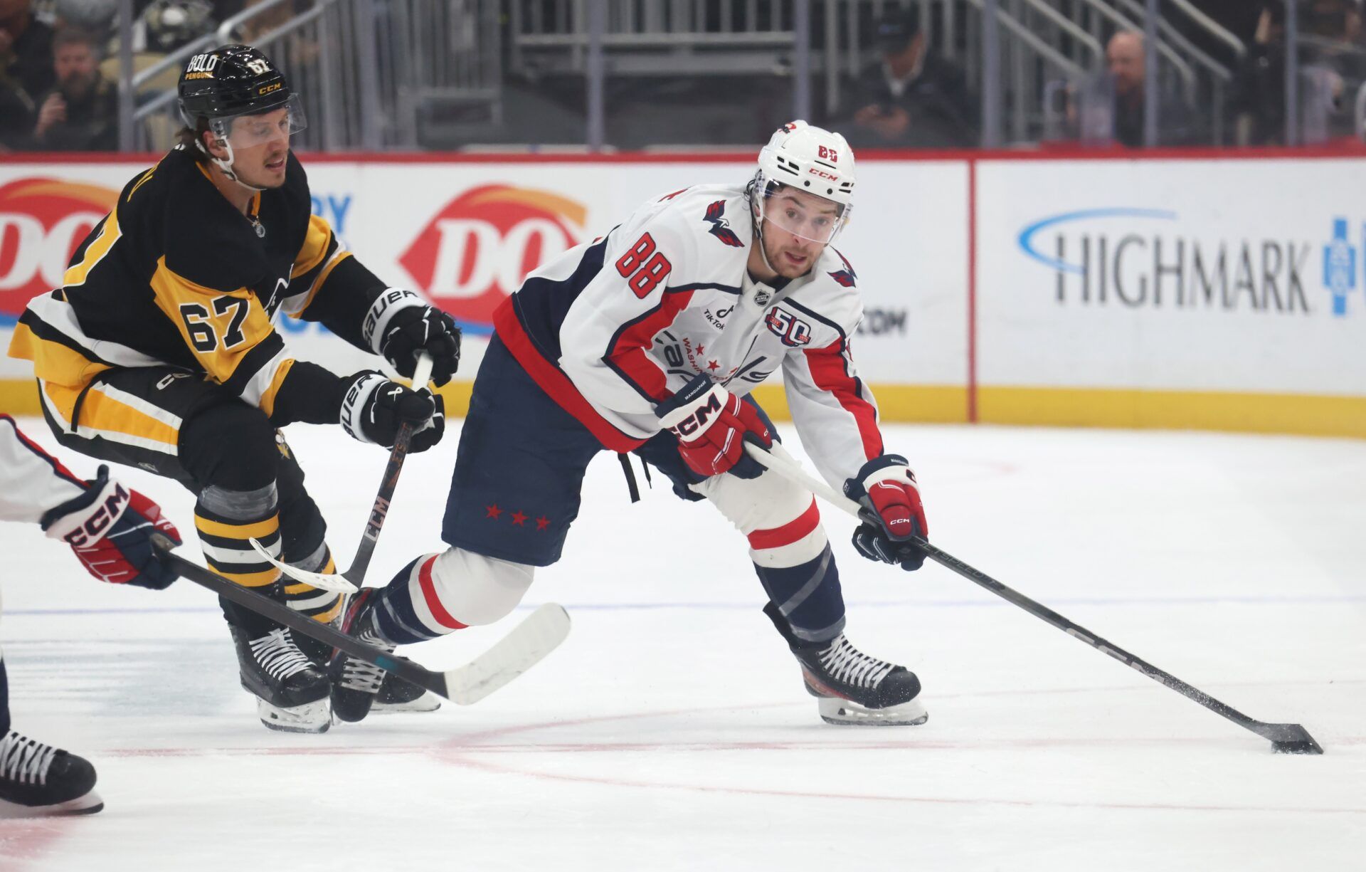 Washington Capitals left wing Andrew Mangiapane (88) moves the puck against Pittsburgh Penguins right wing Rickard Rakell (67) during the first period at PPG Paints Arena.