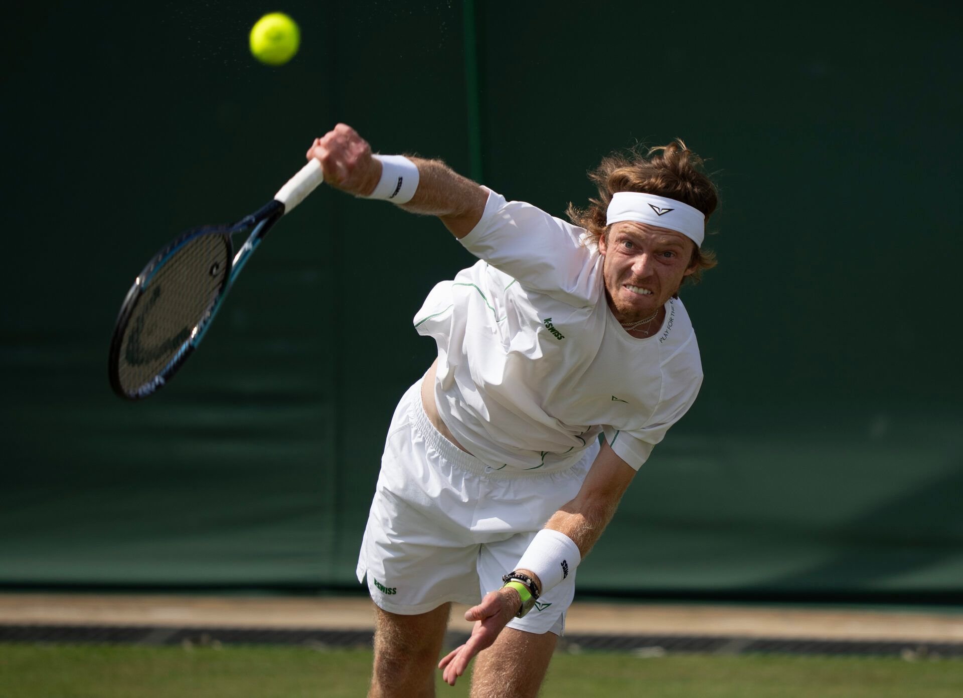 Andrey Rublev serves the ball during his match against Lloyd Harris of South Africa on day three at the All England Lawn Tennis and Croquet Club.