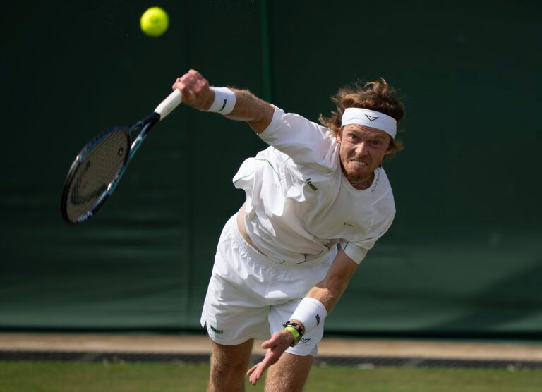 Andrey Rublev serves the ball during his match against Lloyd Harris of South Africa on day three at the All England Lawn Tennis and Croquet Club.