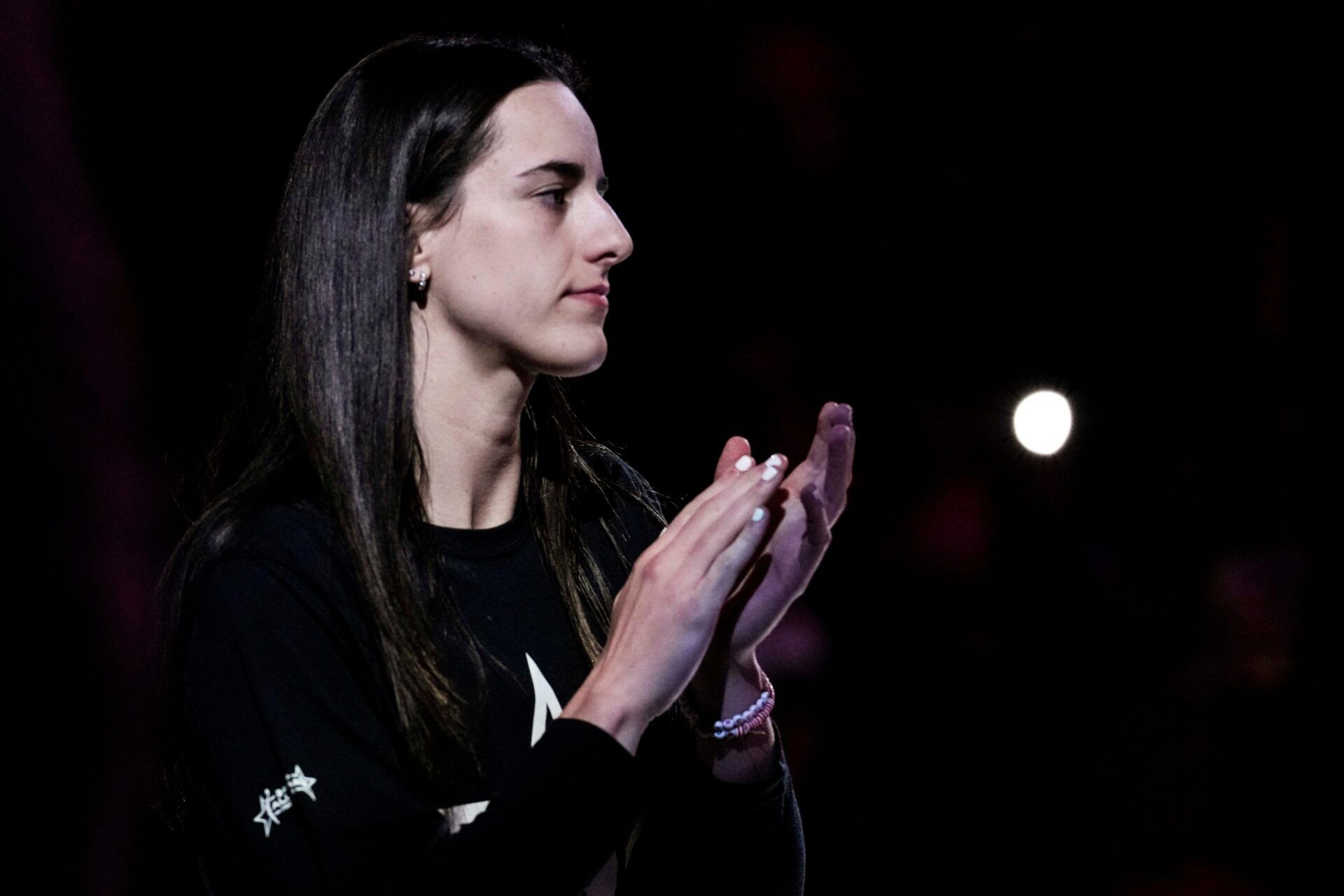 Indiana Fever guard Caitlin Clark (22) claps Thursday, July 3, 2025, during team introductions at a game between the Indiana Fever and the Las Vegas Aces at Gainbridge Fieldhouse in Indianapolis.