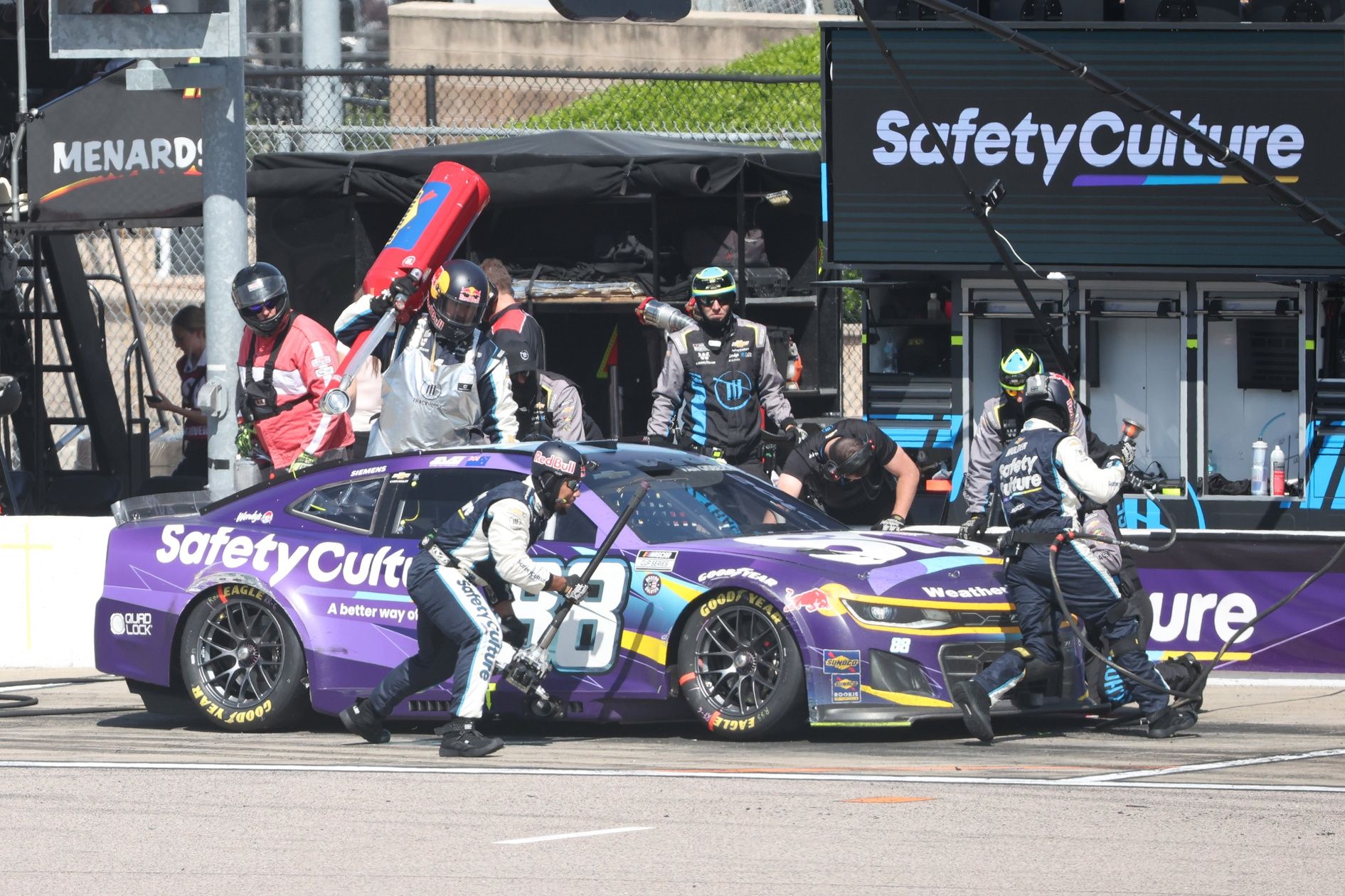 The crew of NASCAR Cup Series driver Shane Van Gisbergen (88) work on his car during a caution at the AdventHealth 400 at Kansas Speedway.