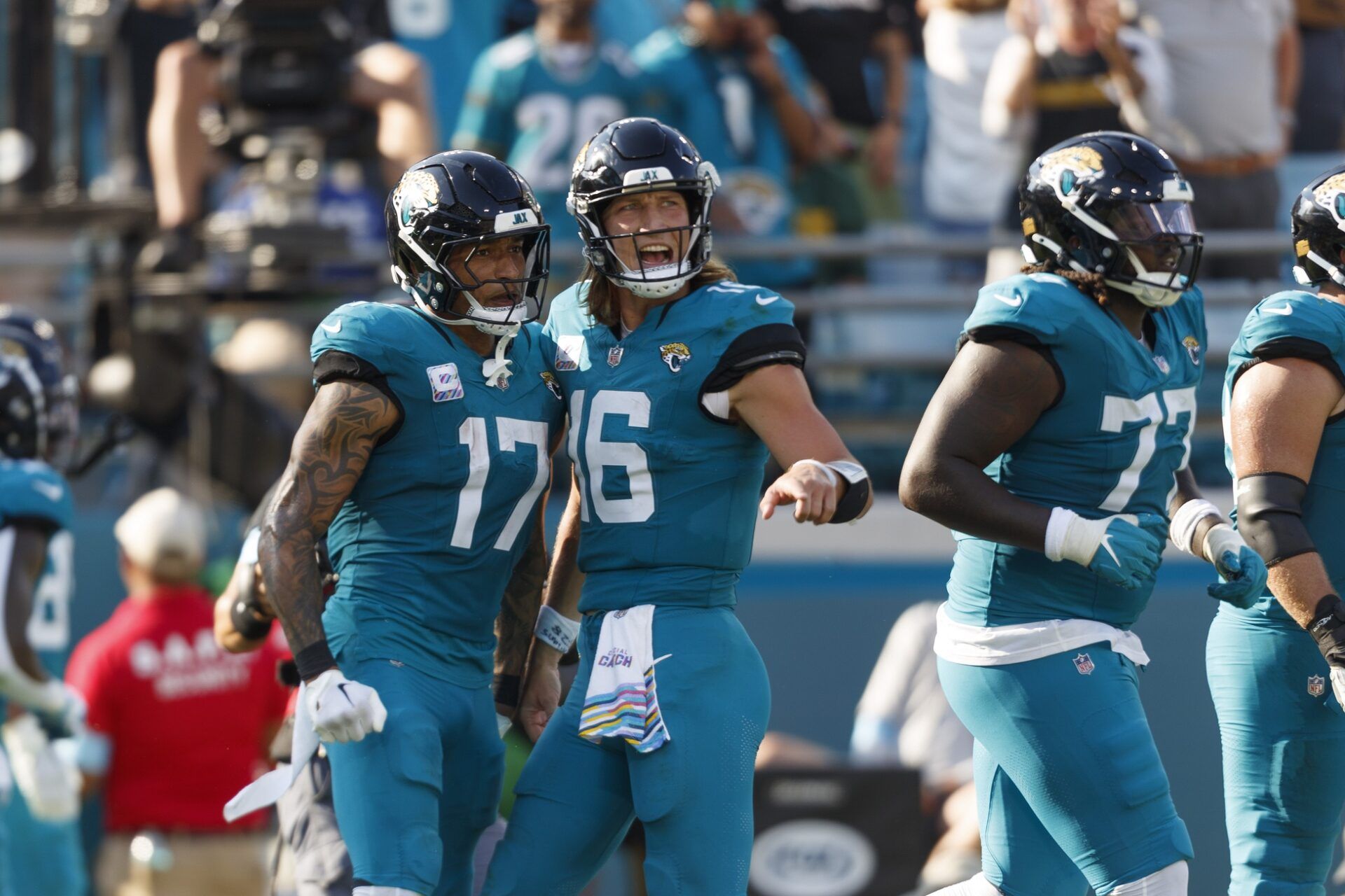 Jacksonville Jaguars tight end Evan Engram (17) and quarterback Trevor Lawrence (16) celebrate a touchdown against the Green Bay Packers during the fourth quarter at EverBank Stadium.