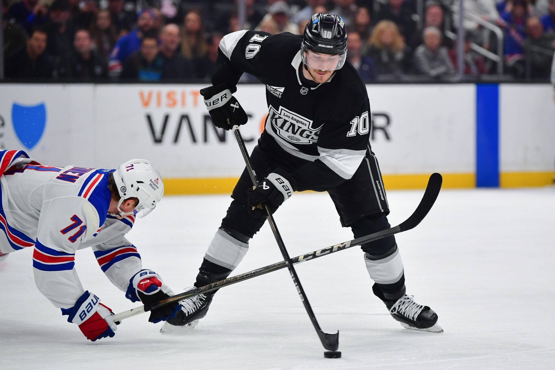 Los Angeles Kings left wing Tanner Jeannot (10) moves the puck against New York Rangers center Juuso Parssinen (71) during the second period at Crypto.com Arena.