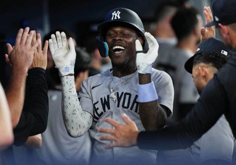 New York Yankees third baseman Jazz Chisholm Jr. (13) celebrates in the dugout after hitting a two-run home run against the Toronto Blue Jays during the fourth inning at Rogers Centre.