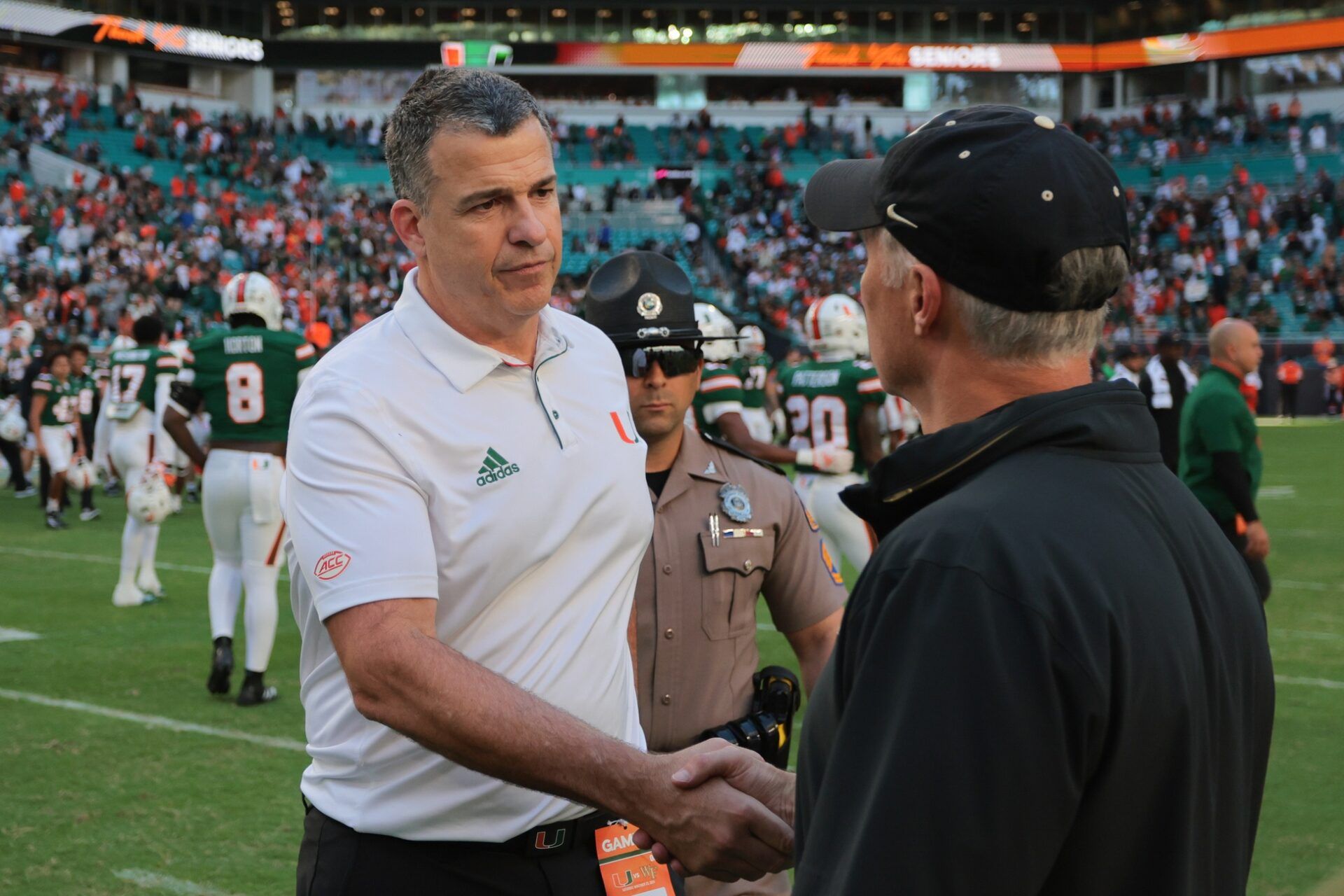 Miami Hurricanes head coach Mario Cristobal shakes hands with Wake Forest Demon Deacons head coach Dave Clawson after the game at Hard Rock Stadium.