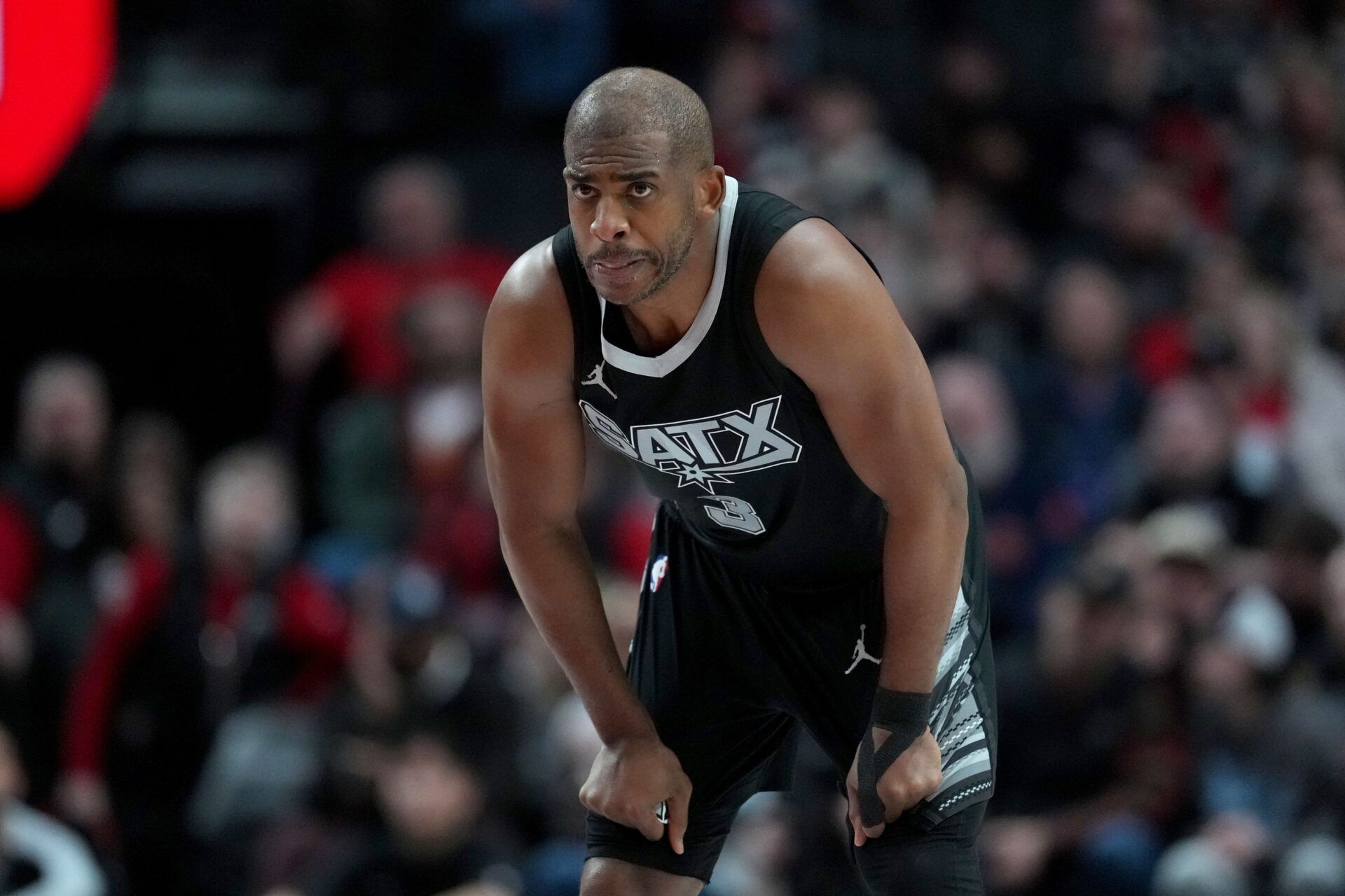 San Antonio Spurs point guard Chris Paul (3) looks on during the first half against the Portland Trail Blazers at Moda Center.