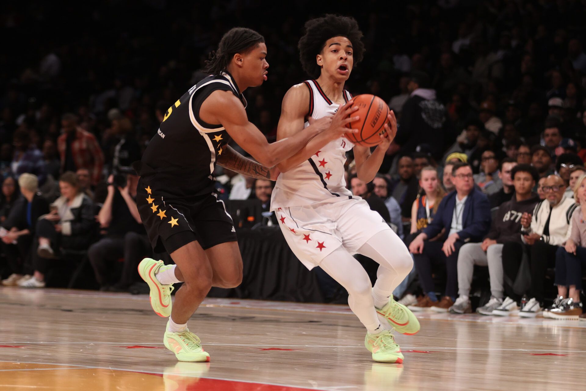 McDonald's All American West guard Mikel Brown Jr. (11) dribbles the ball against McDonald's All American East guard Darius Acuff Jr. (5) during the first half of the game at Barclays Center.