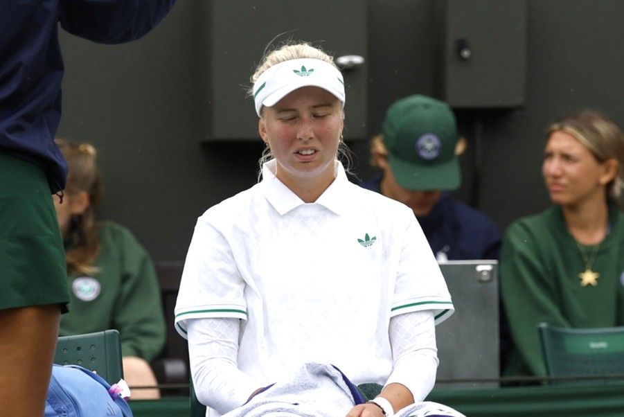 Clara Tauson (DEN)(M) talks with the chair umpire during a rain delay in her match against Elena Rybakina (KAZ)(not pictured) on day six of The Championships Wimbledon 2025 at All England Lawn Tennis and Croquet Club.