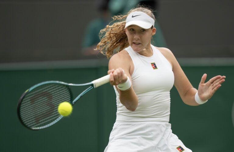 Mirra Andreeva returns a shot during her match against Hailey Baptiste of the United States on day six at the All England Lawn Tennis and Croquet Club.