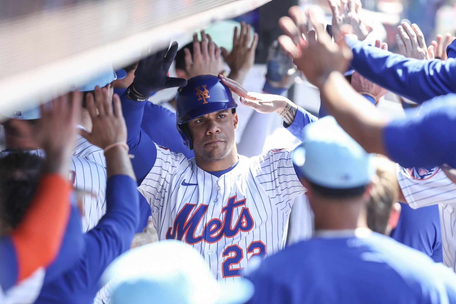 New York Mets right fielder Juan Soto (22) is greeted in the dugout after hitting a two run home run in the first inning against the New York Yankees at Citi Field.