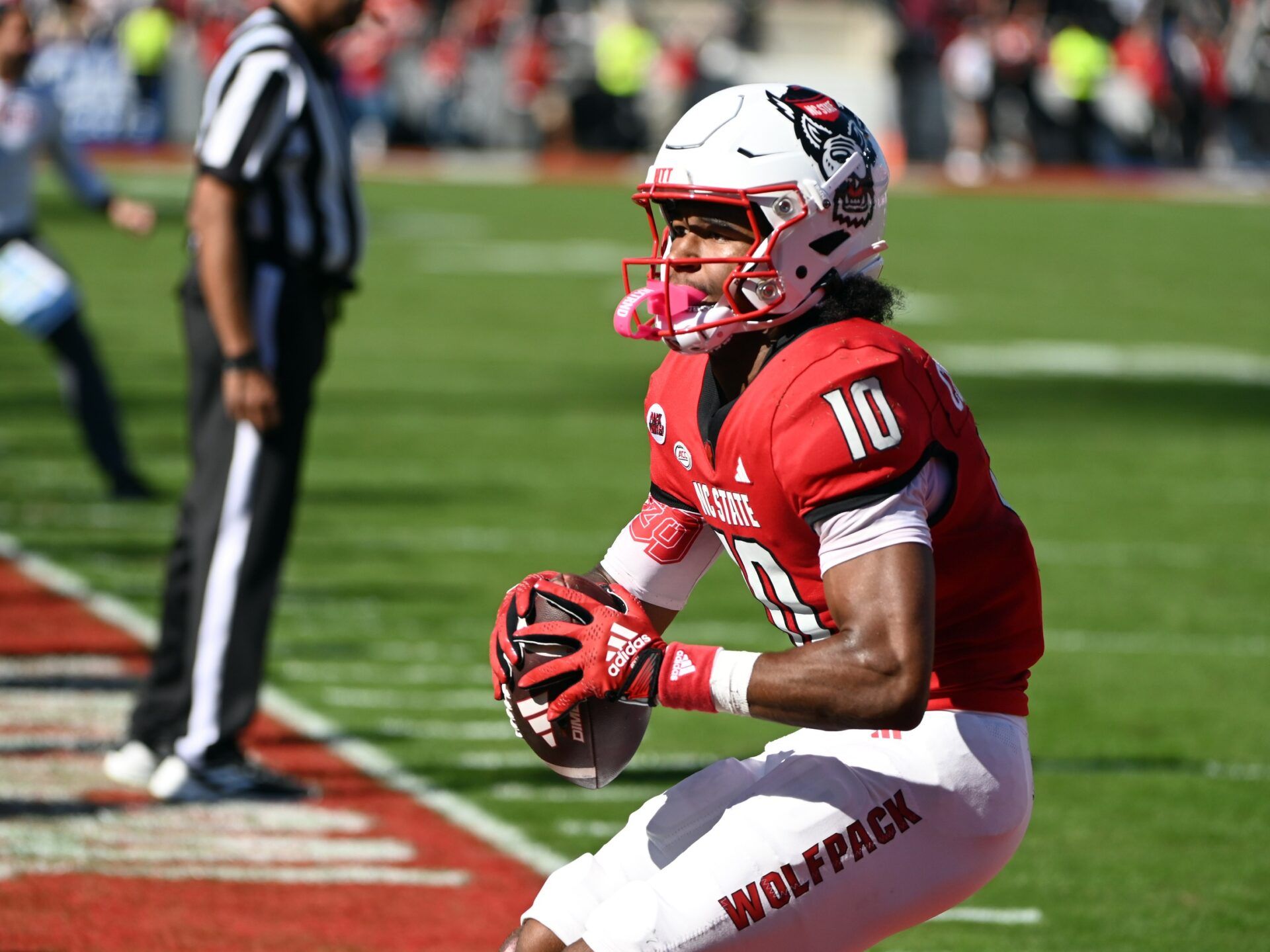 North Carolina State Wolfpack receiver KC Concepcion (10) reacts after scoring a touchdown during the first half against the Clemson Tigers at Carter-Finley Stadium.