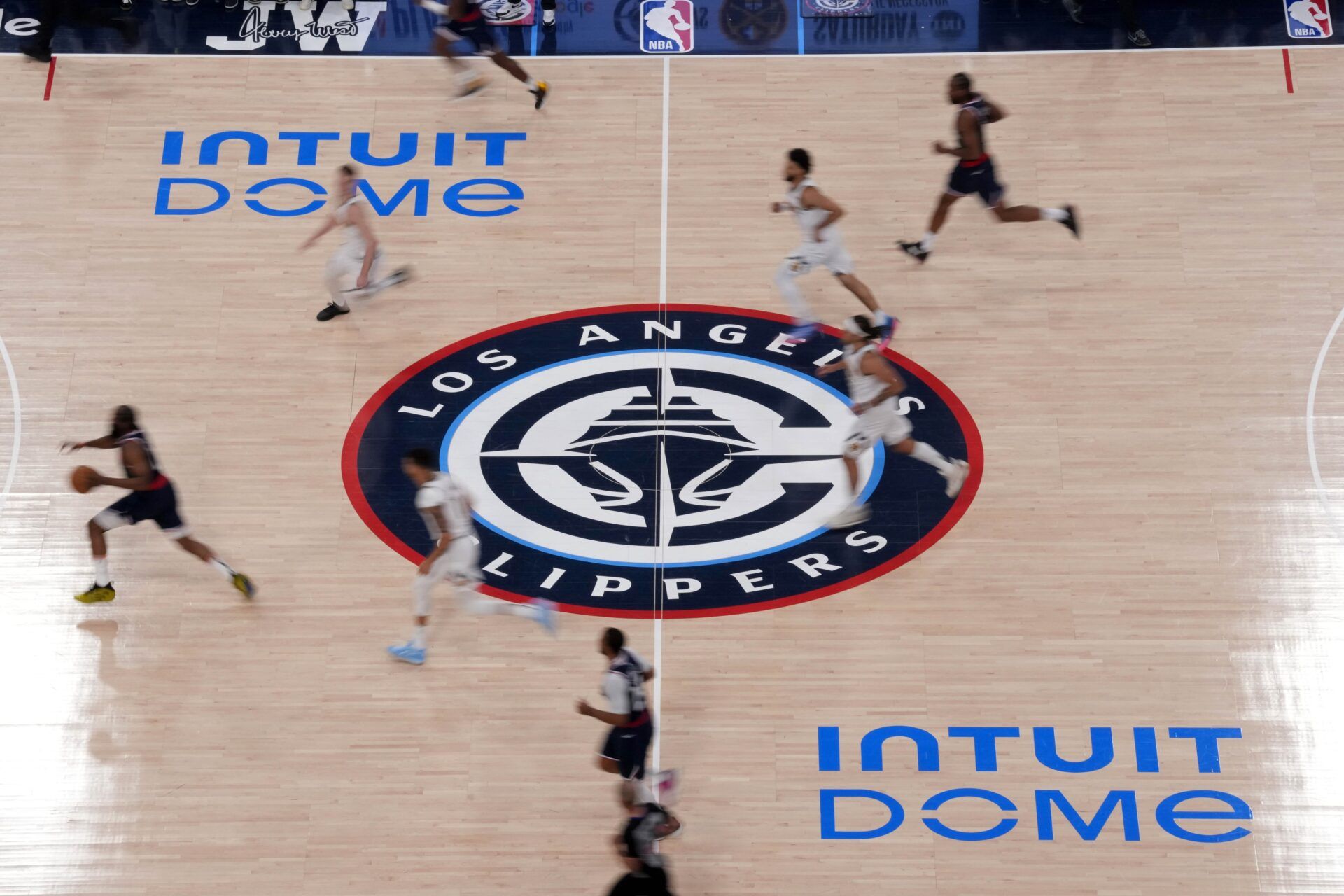 A general overall view as LA Clippers guard James Harden (1) dribbles the ball across the Clippers logo at midcourt in the first half against the Denver Nuggets during game six of first round for the 2025 NBA Playoffs at Intuit Dome.
