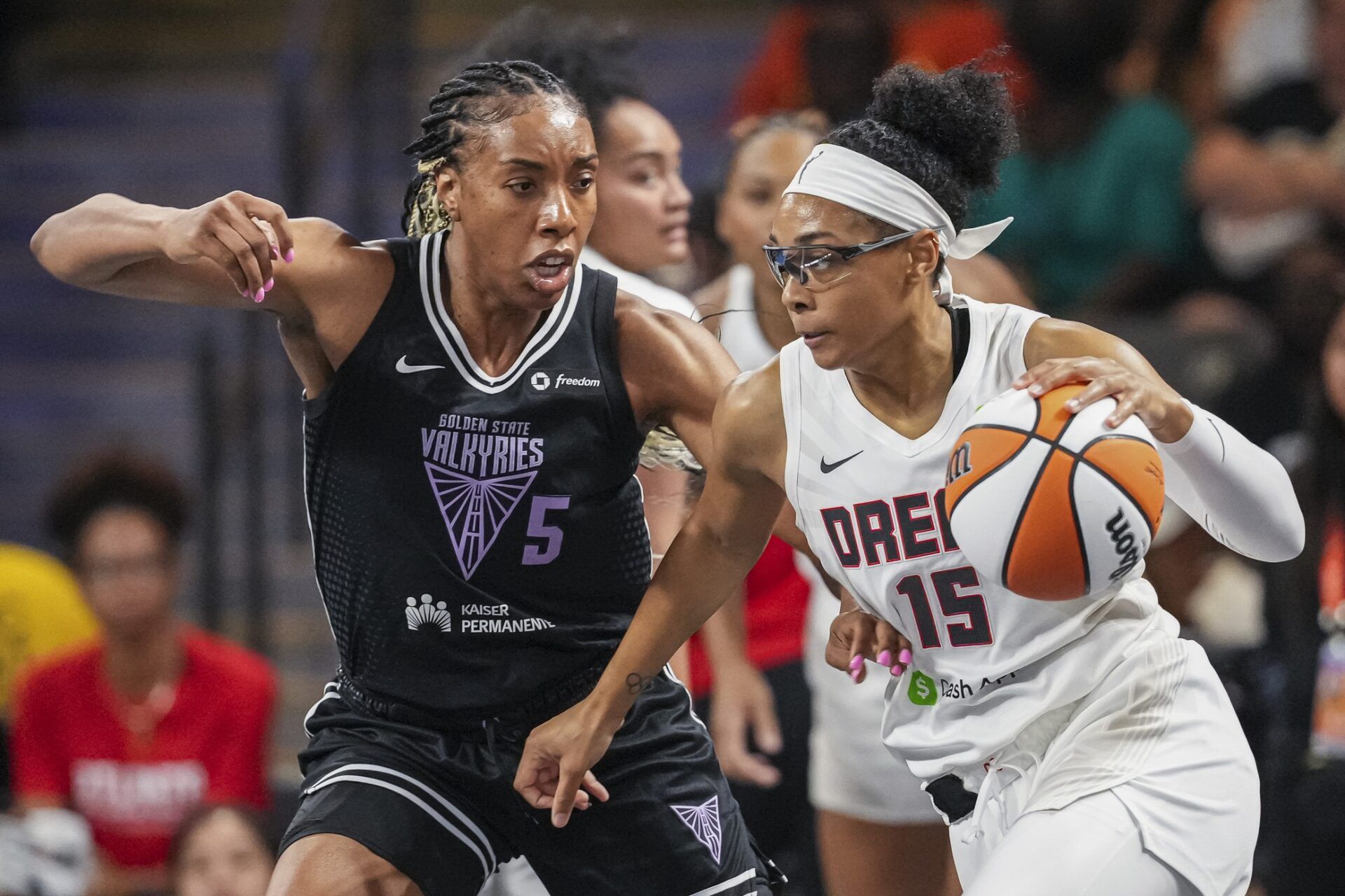 Atlanta Dream guard Allisha Gray (15) dribbles against Golden State Valkyries forward Kayla Thornton (5) during the first half at Gateway Center Arena at College Park.