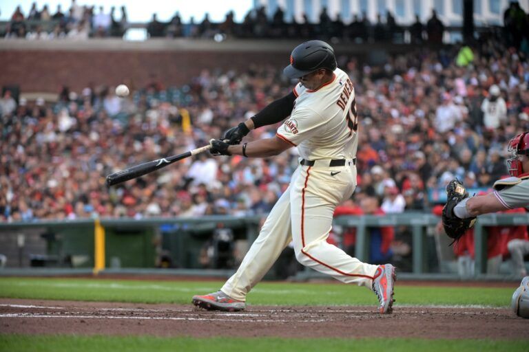 San Francisco Giants designated hitter Rafael Devers (16) hits a single during the third inning of the game against the Philadelphia Phillies at Oracle Park.