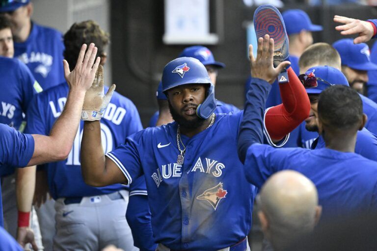 Toronto Blue Jays first base Vladimir Guerrero Jr. (27) celebrates in the dugout after he  scores during the fourth inning against the Chicago White Sox at Rate Field.