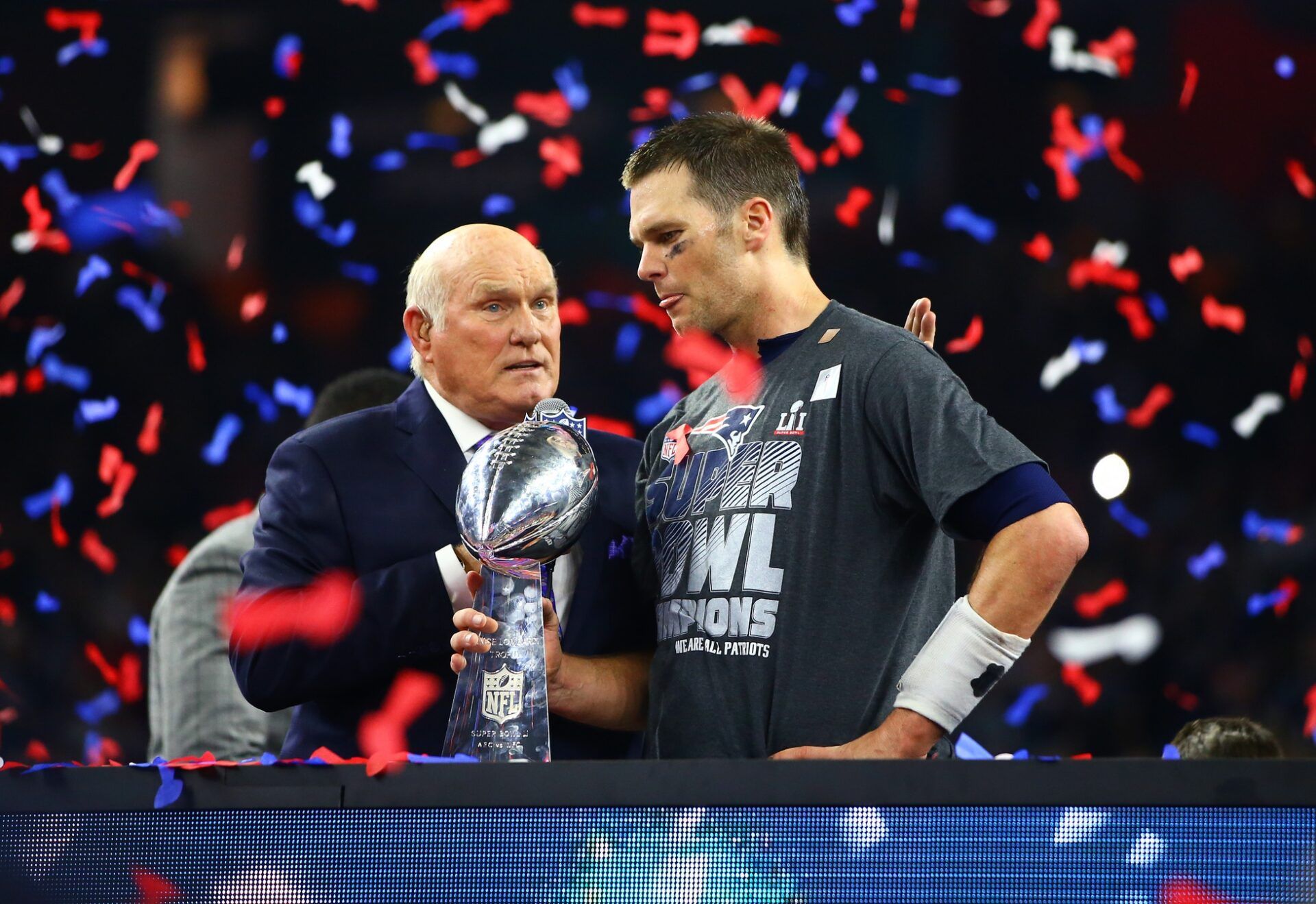Fox television announcer Terry Bradshaw (left) presents New England Patriots quarterback Tom Brady with the Vince Lombardi trophy after defeating the Atlanta Falcons during Super Bowl LI at NRG Stadium.