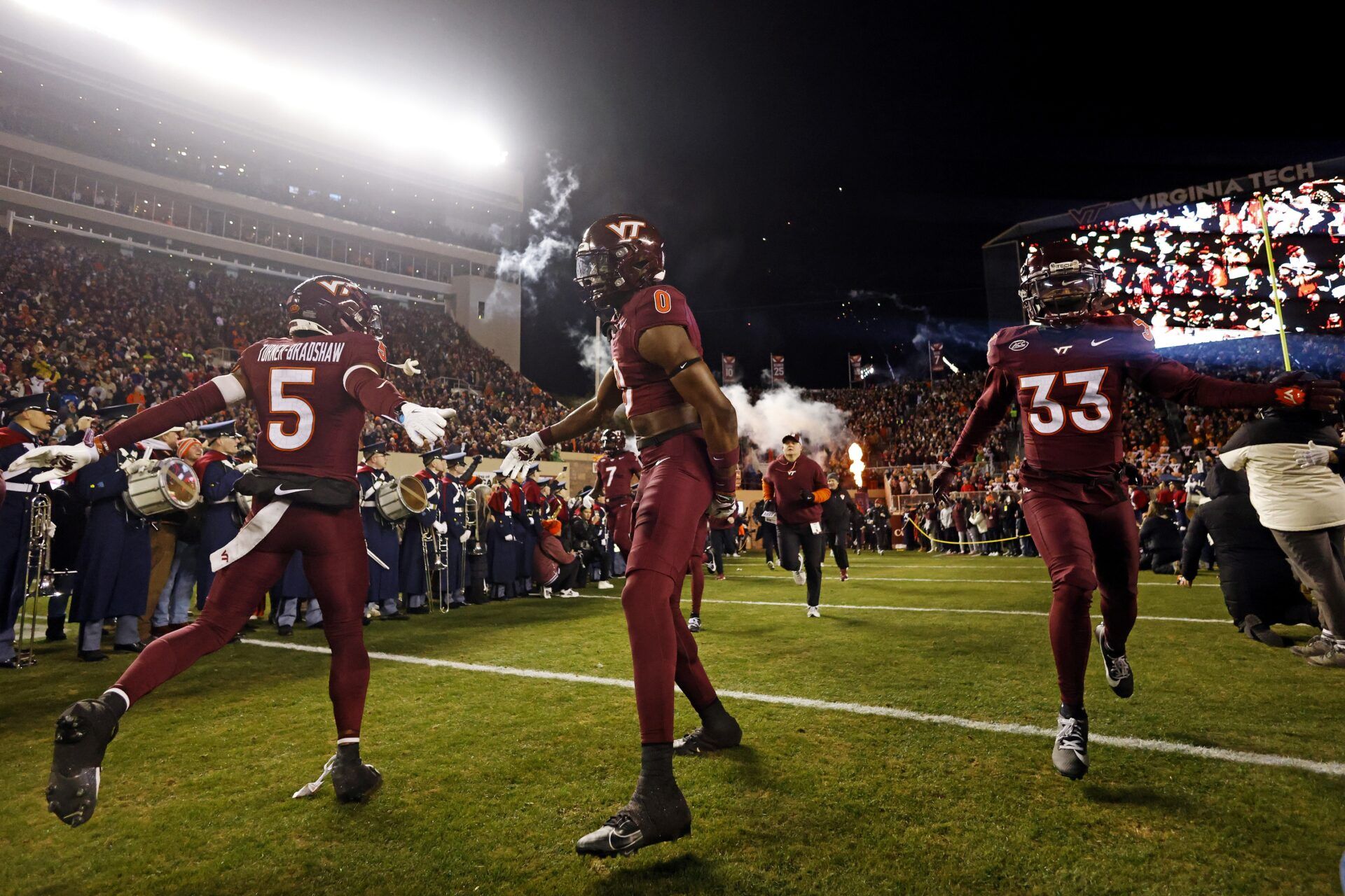 The Virginia Tech Hokies runs onto the field during “Enter Sandman” before playing against the Virginia Cavaliers at Lane Stadium.