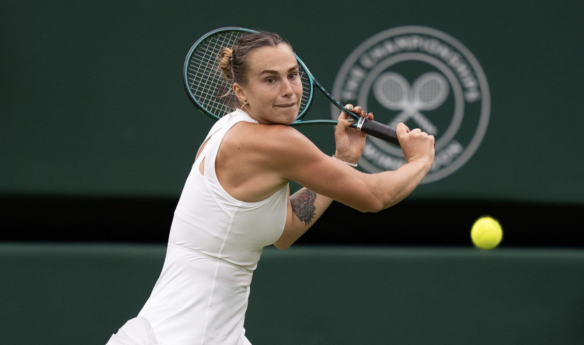 Aryna Sabalenka returns a shot during her match against Elise Mertens of Belgium on day seven at the All England Lawn Tennis and Croquet Club.