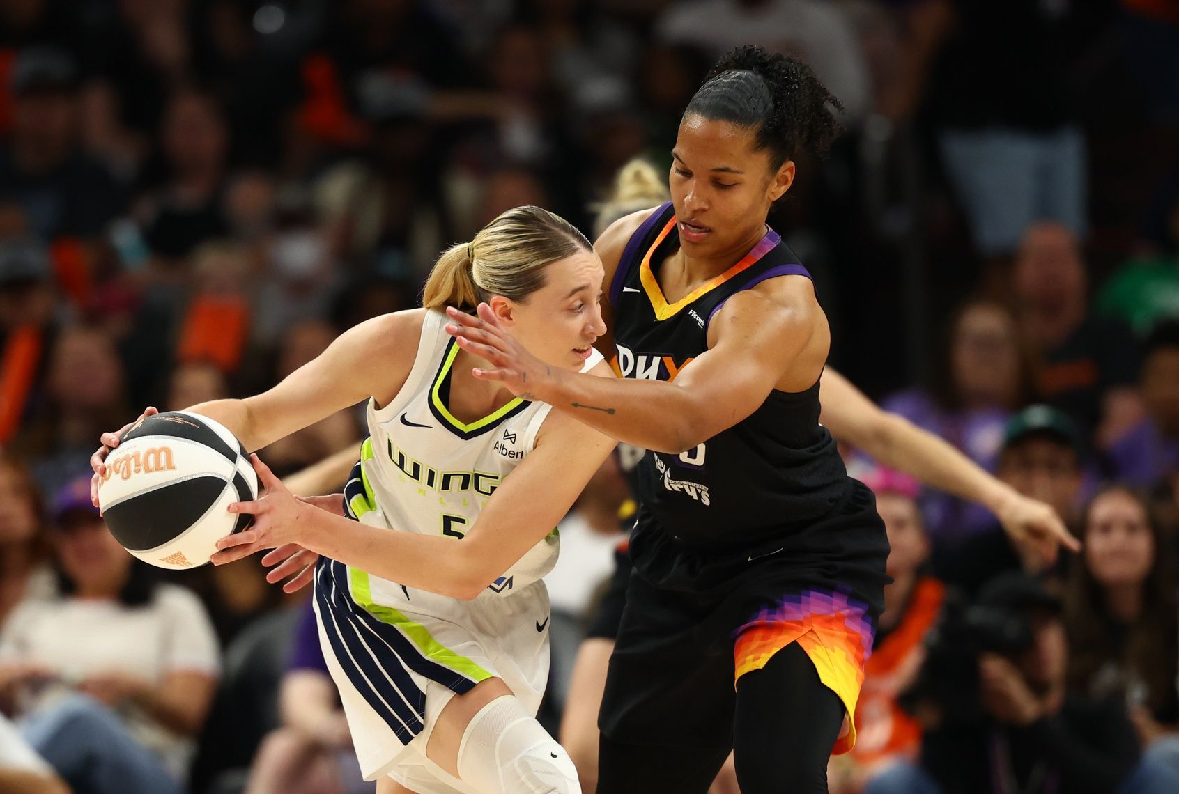 Dallas Wings guard Paige Bueckers (5) against Phoenix Mercury forward Alyssa Thomas (25) in the first half at PHX Arena.