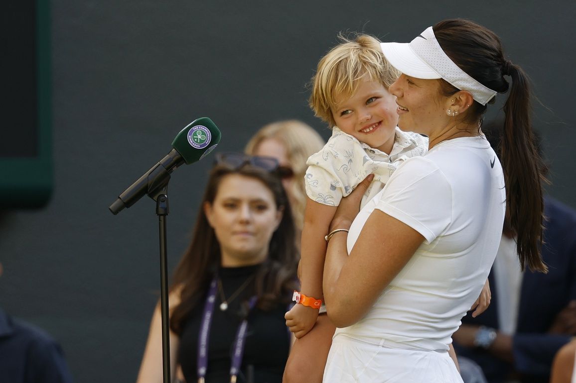 Amanda Anisimova (USA) gives her on-court post match interview while holding her nephew Jackson after her match against Anastasia Pavlyuchenkova (not pictured) in a ladies' singles quarter-final on day eight of The Championships Wimbledon 2025 at All England Lawn Tennis and Croquet Club.