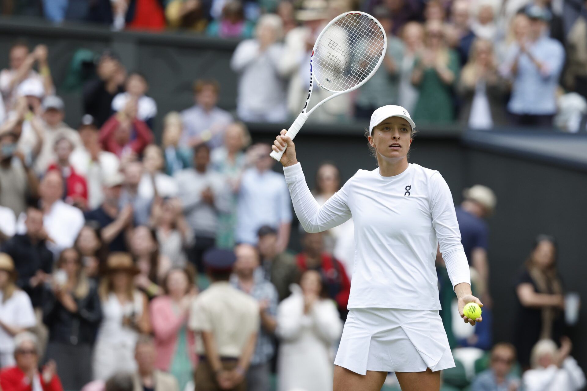Iga Swiatek (POL)  salutes the crowd after her match against Petra Martic (CRO)(not pictured) after their match in ladies' singles on day four of The Championships Wimbledon 2024 at All England Lawn Tennis and Croquet Club.