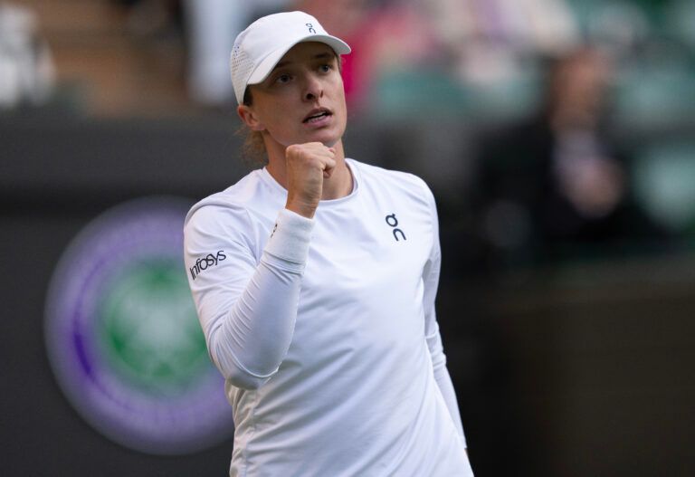 Iga Swiatek of Poland reacts to a point during her match against Clara Tauson of Denmark on day eight at All England Lawn Tennis and Croquet Club.