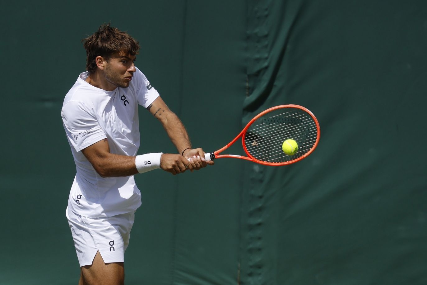 Flavio Cobolli (ITA) hits a backhand against Marin Cilic (CRO)(not pictured) on day eight of The Championships Wimbledon 2025 at All England Lawn Tennis and Croquet Club.