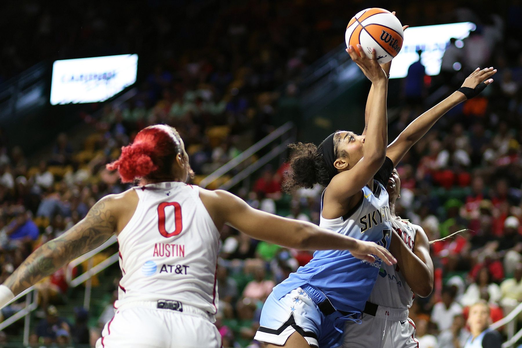 Chicago Sky forward Angel Reese (5) takes a shot over Washington Mystics forward Shakira Austin (0) during the second half at EagleBank Arena.