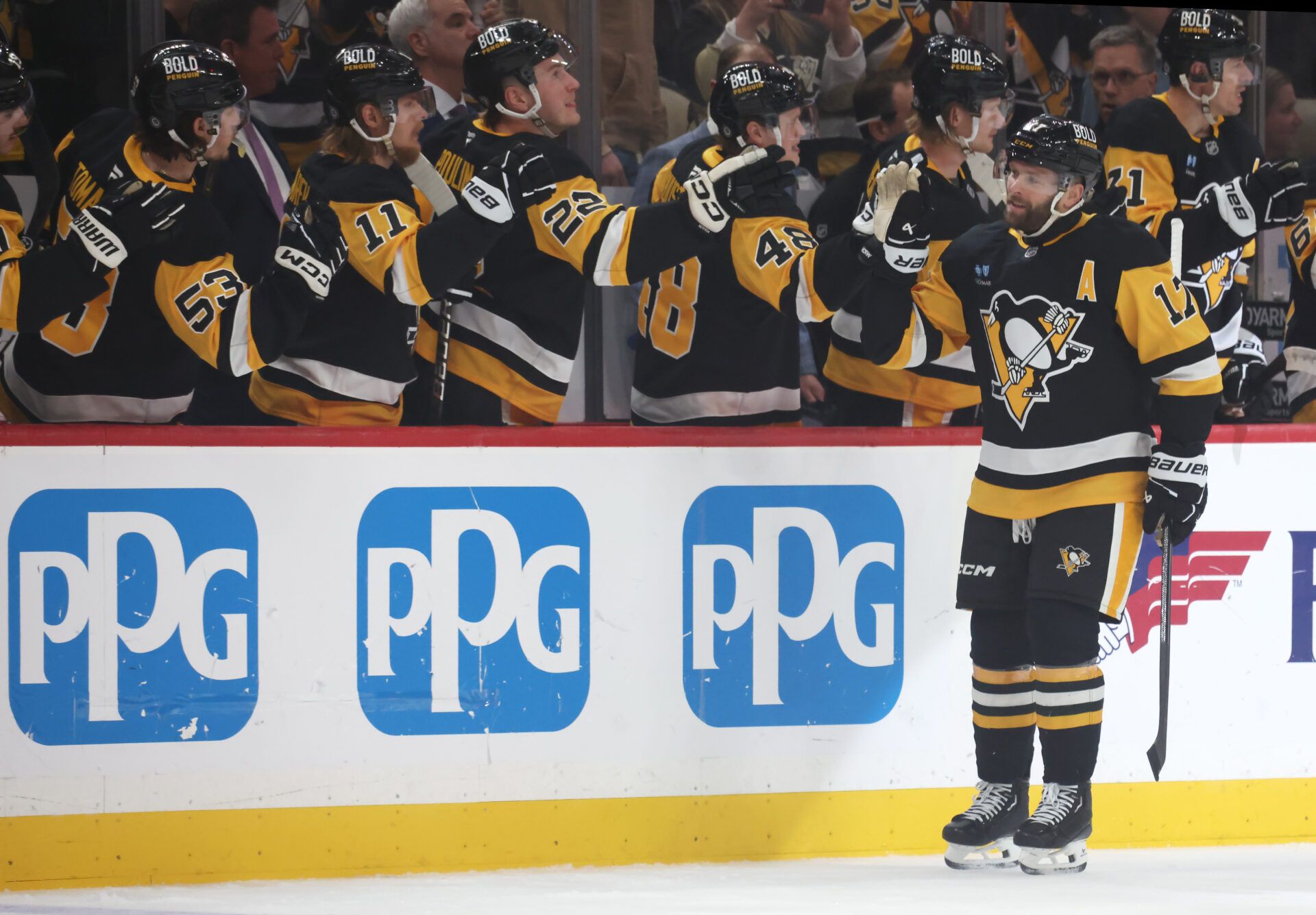 Pittsburgh Penguins right wing Bryan Rust (17) celebrates his goal with the Penguins bench against the Washington Capitals during the first period at PPG Paints Arena.