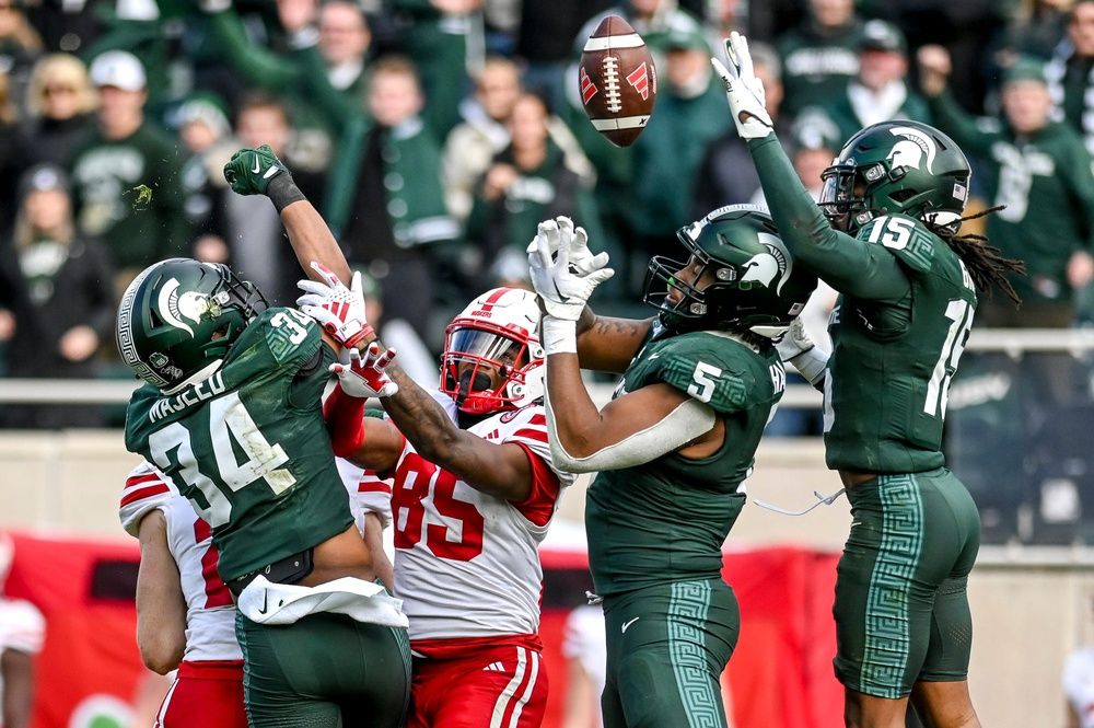 From left, Michigan State's Khalil Majeed, Jordan Hall and Angelo Grose break up a pass intended for Nebraska's Jaidyn Doss to end the game on Saturday, Nov. 4, 2023, at Spartan Stadium in East Lansing.
