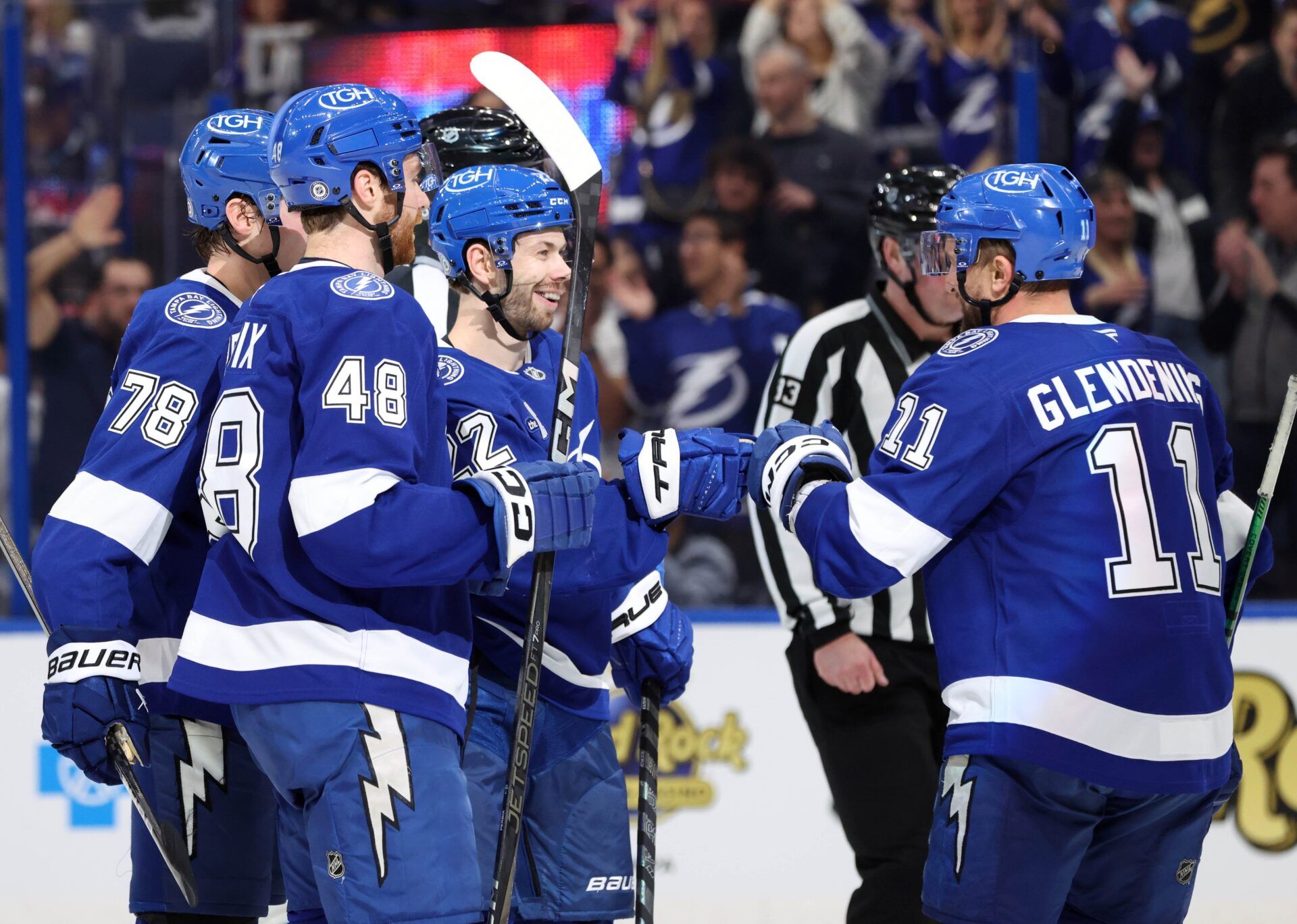 Tampa Bay Lightning right wing Oliver Bjorkstrand (22) is congratulated after he scored  a goal against the Utah Hockey Club during the third period at Amalie Arena.