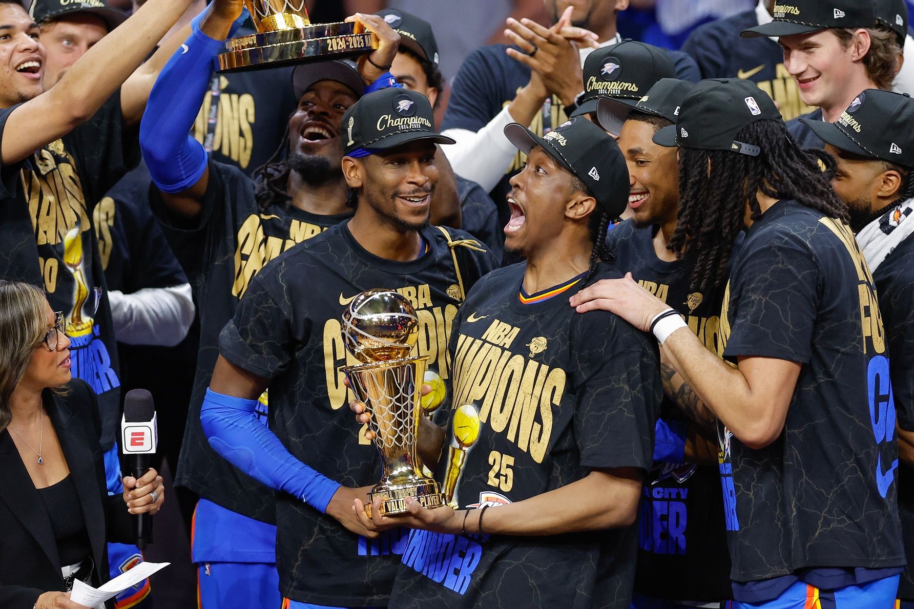 Oklahoma City Thunder forward Jalen Williams (8) holds up the Bill Russell NBA Finals MVP trophy after winner Oklahoma City Thunder guard Shai Gilgeous-Alexander hands it to him at the end of game seven of the 2025 NBA Finals against the Indiana Pacers at Paycom Center.