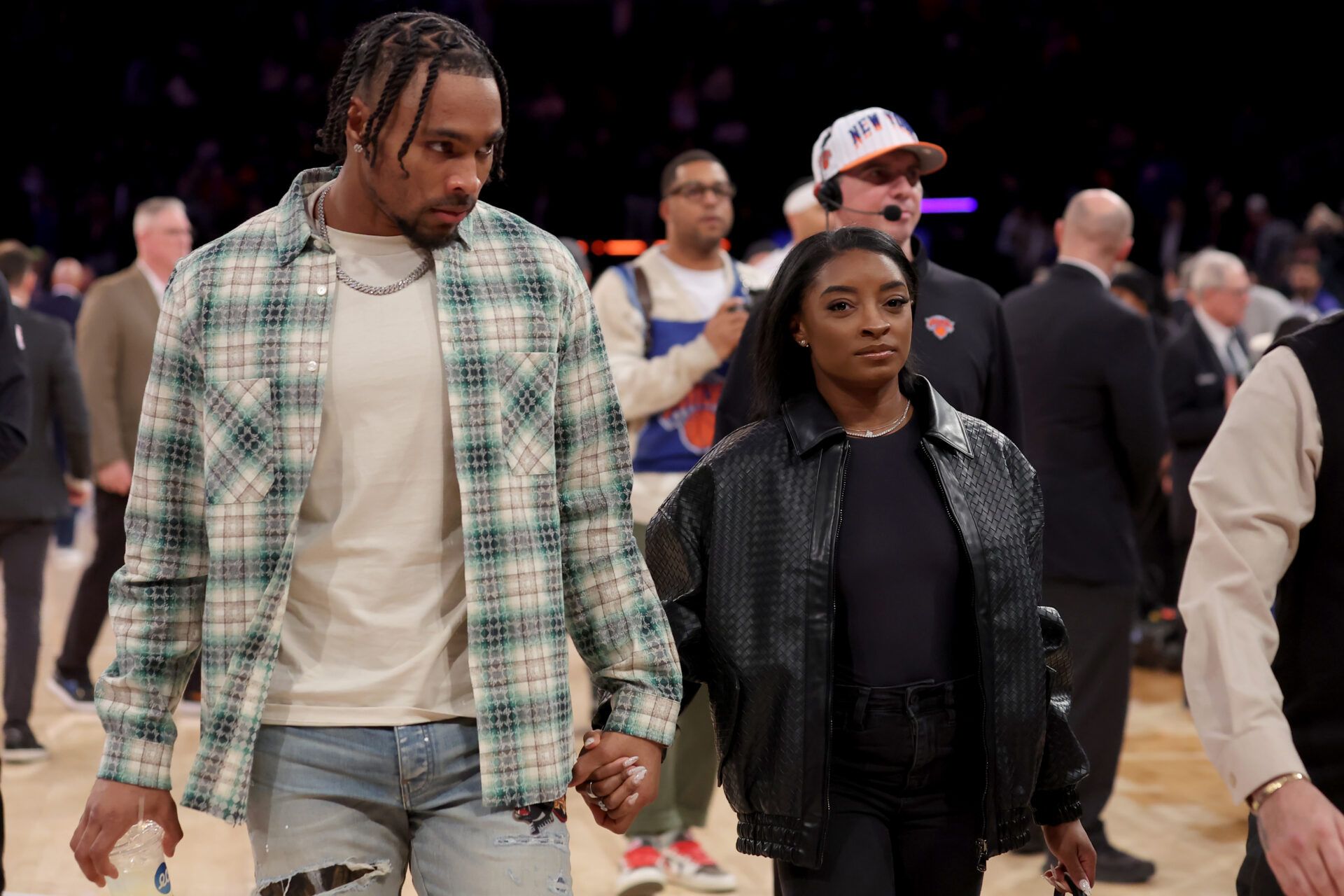 American gymnast Simone Biles (right) and her husband NFL player Jonathan Owens walk off the court following a game between the New York Knicks and the Oklahoma City Thunder at Madison Square Garden.