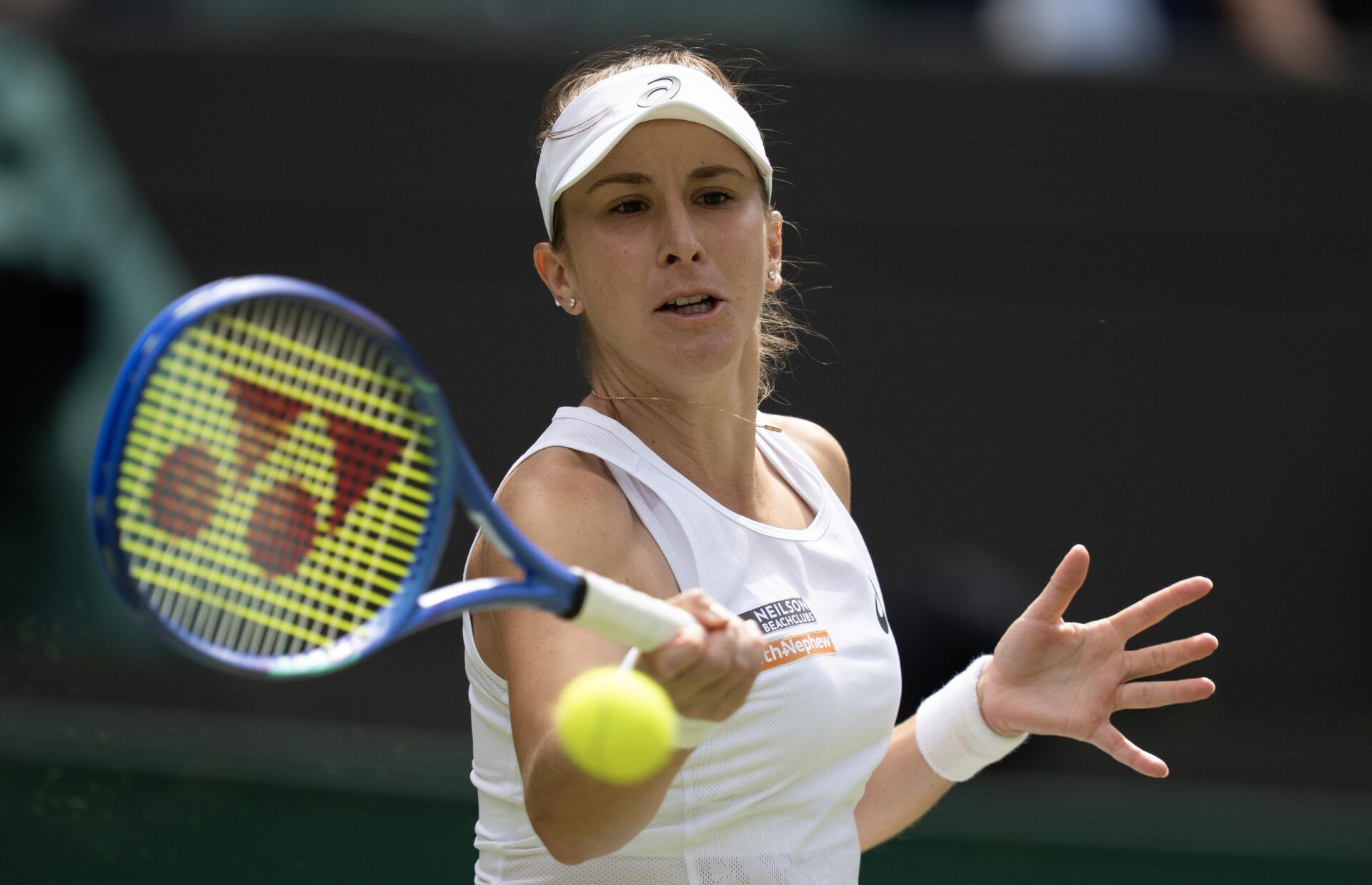 Belinda Bencic of Switzerland returns a shot during her match against Ekaterina Alexandrova on day eight at All England Lawn Tennis and Croquet Club.