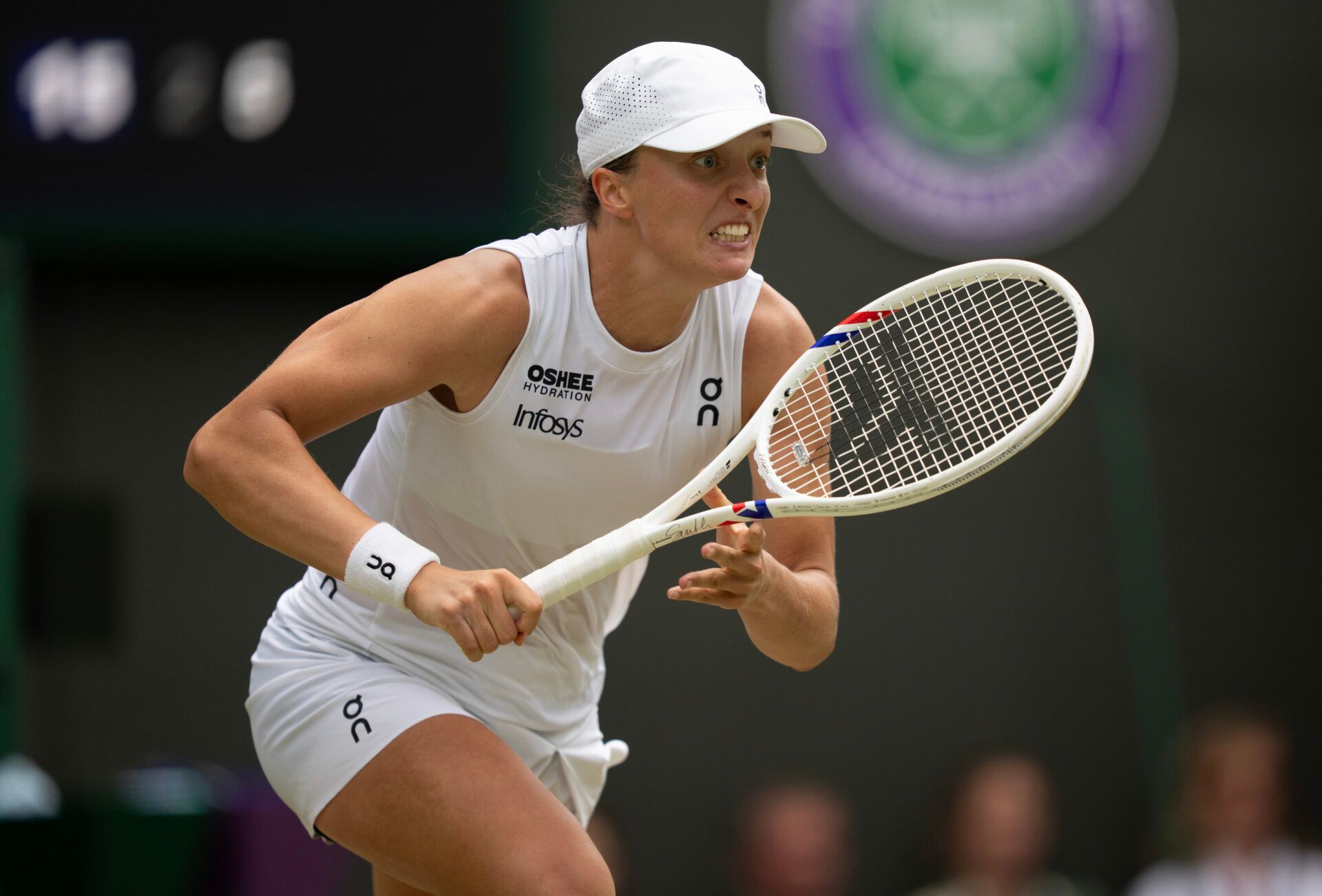 Iga Swiatek of Poland runs for the ball during her match against Liudmila Samsonova on day 10 at All England Lawn Tennis and Croquet Club.