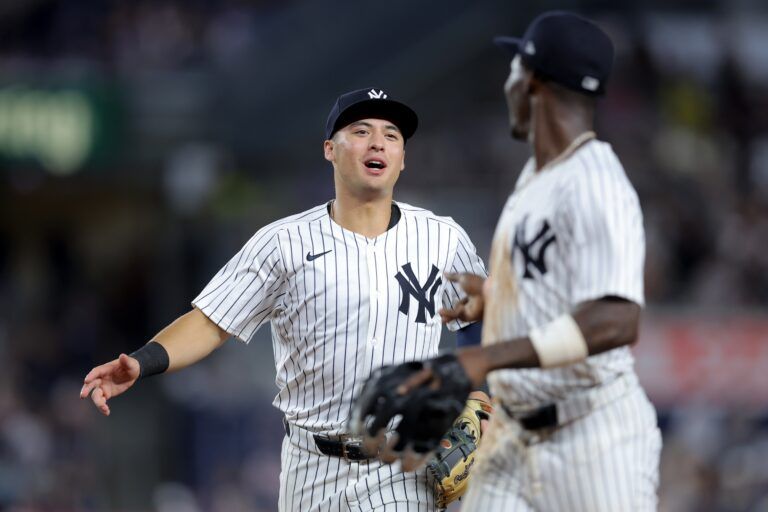 New York Yankees shortstop Anthony Volpe (11) and second baseman Jazz Chisholm Jr. (13) react after turning a double play on a ball hit by Seattle Mariners first baseman Donovan Solano (not pictured) to end the top of the eighth inning at Yankee Stadium.