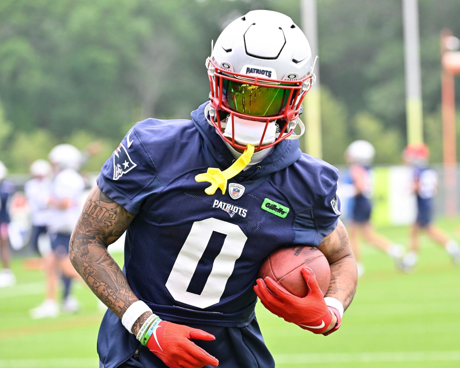 New England Patriots cornerback Christian Gonzalez (0) runs after the catch during minicamp at Gillette Stadium.