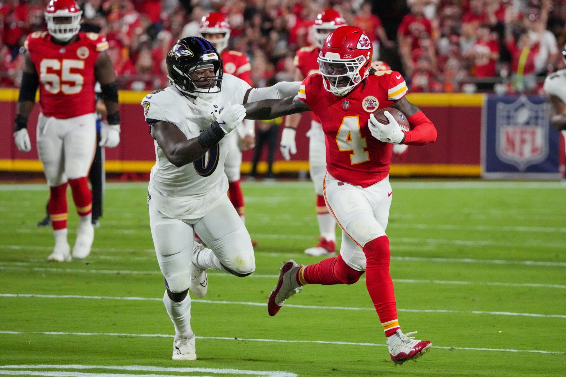 Kansas City Chiefs wide receiver Rashee Rice (4) runs the ball as Baltimore Ravens linebacker Roquan Smith (0) defends during the first half at GEHA Field at Arrowhead Stadium.
