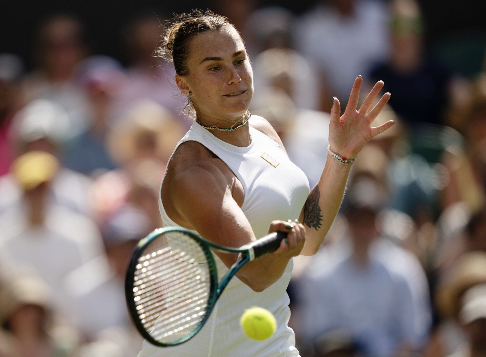 Aryna Sabalenka returns a shot during her match against Amanda Anisimova of the United States on day 11 at All England Lawn Tennis and Croquet Club.