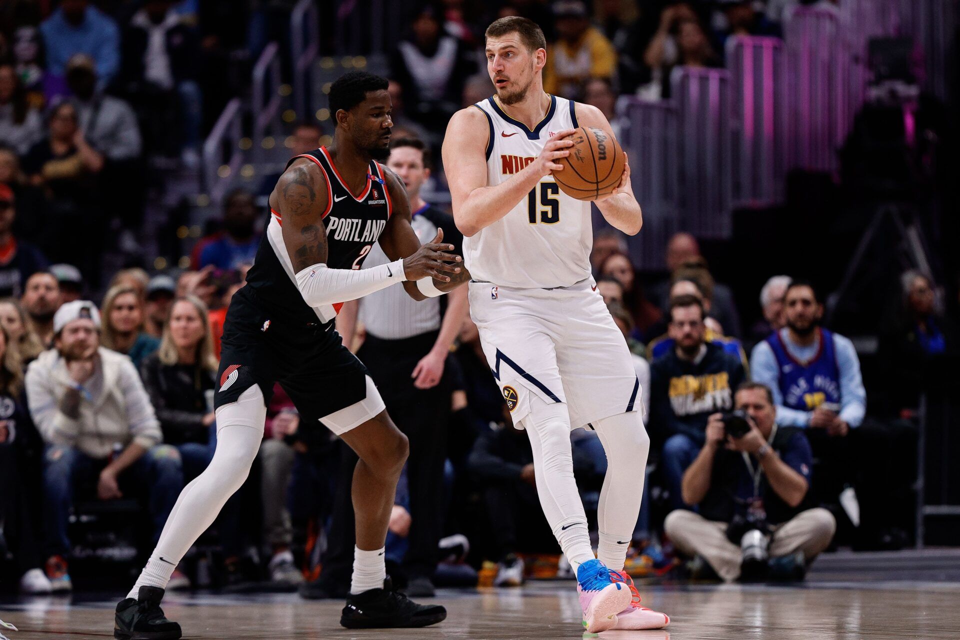 Denver Nuggets center Nikola Jokic (15) controls the ball as Portland Trail Blazers center Deandre Ayton (2) guards in the first quarter at Ball Arena.