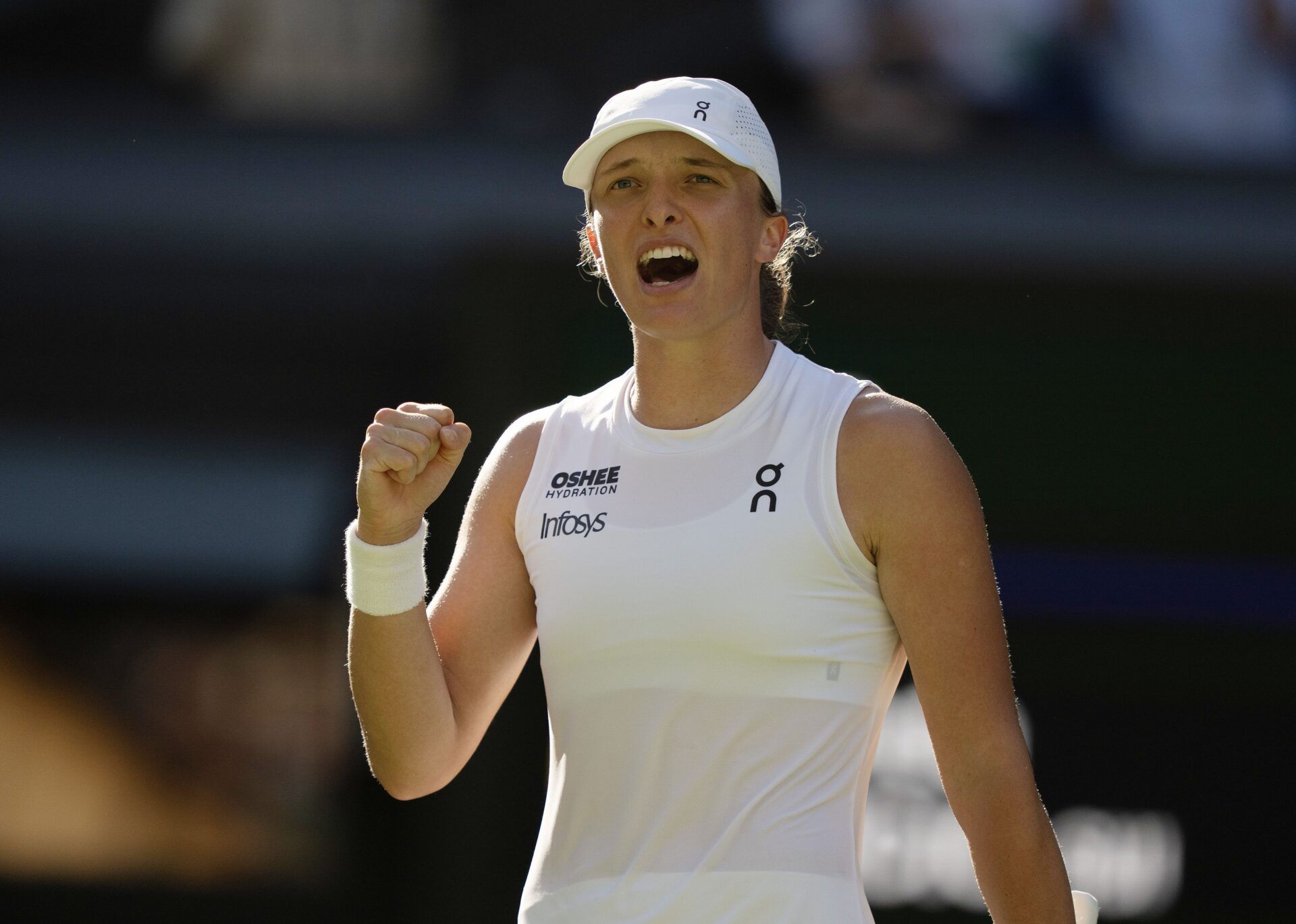 Iga Swiatek of Poland celebrates winning her match against Belinda Bencic of Switzerland on day 11 at All England Lawn Tennis and Croquet Club.